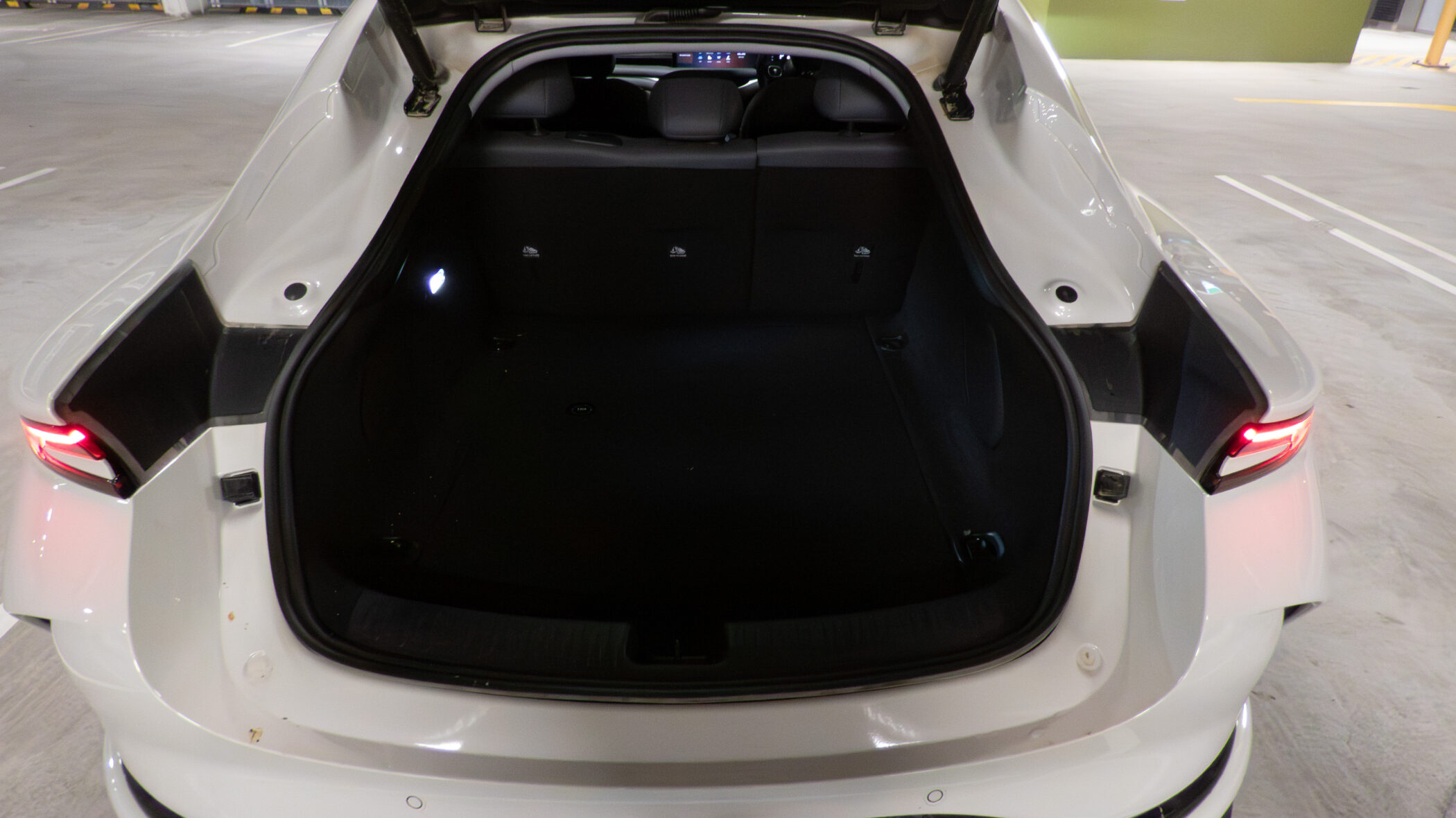 Trunk space available in the IM5 Performance 2025 with the rear seats upright Close-up of the electric charging port door open on the IM5 Performance 2025