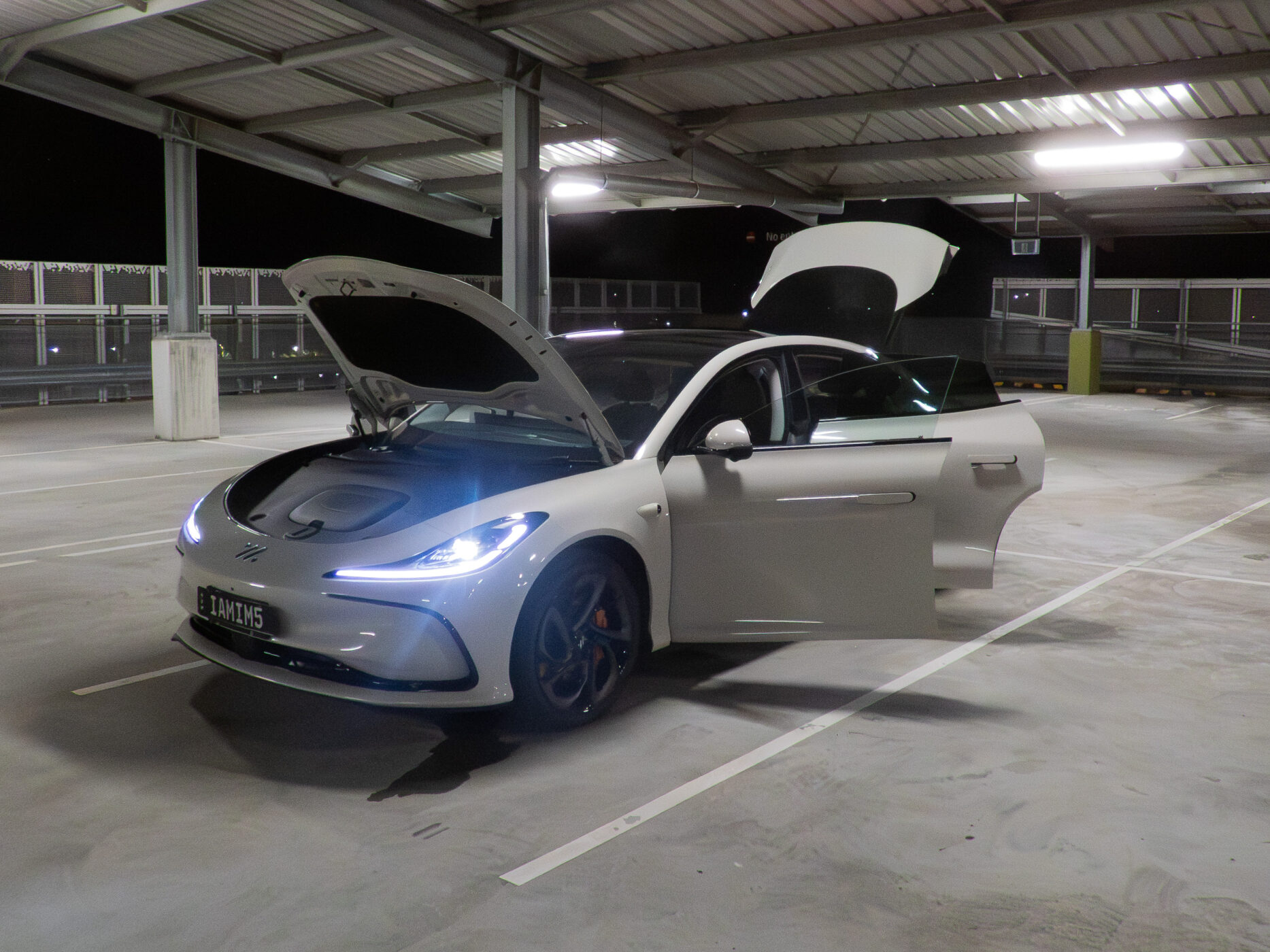 IM5 Performance 2025 with all four doors open, viewed from the front angle