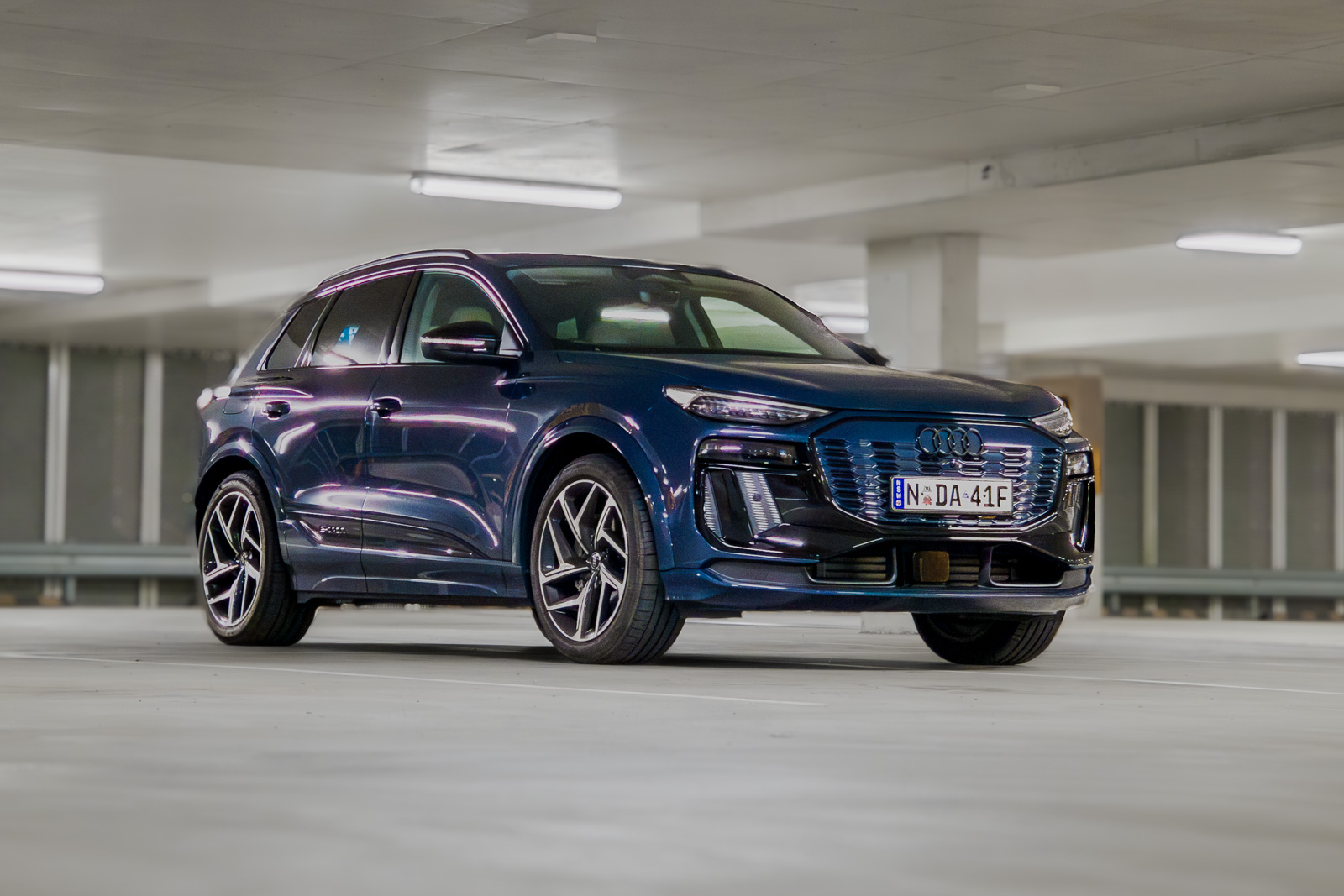 Cinematic hero shot of the 2025 Audi Q6 e-tron electric SUV