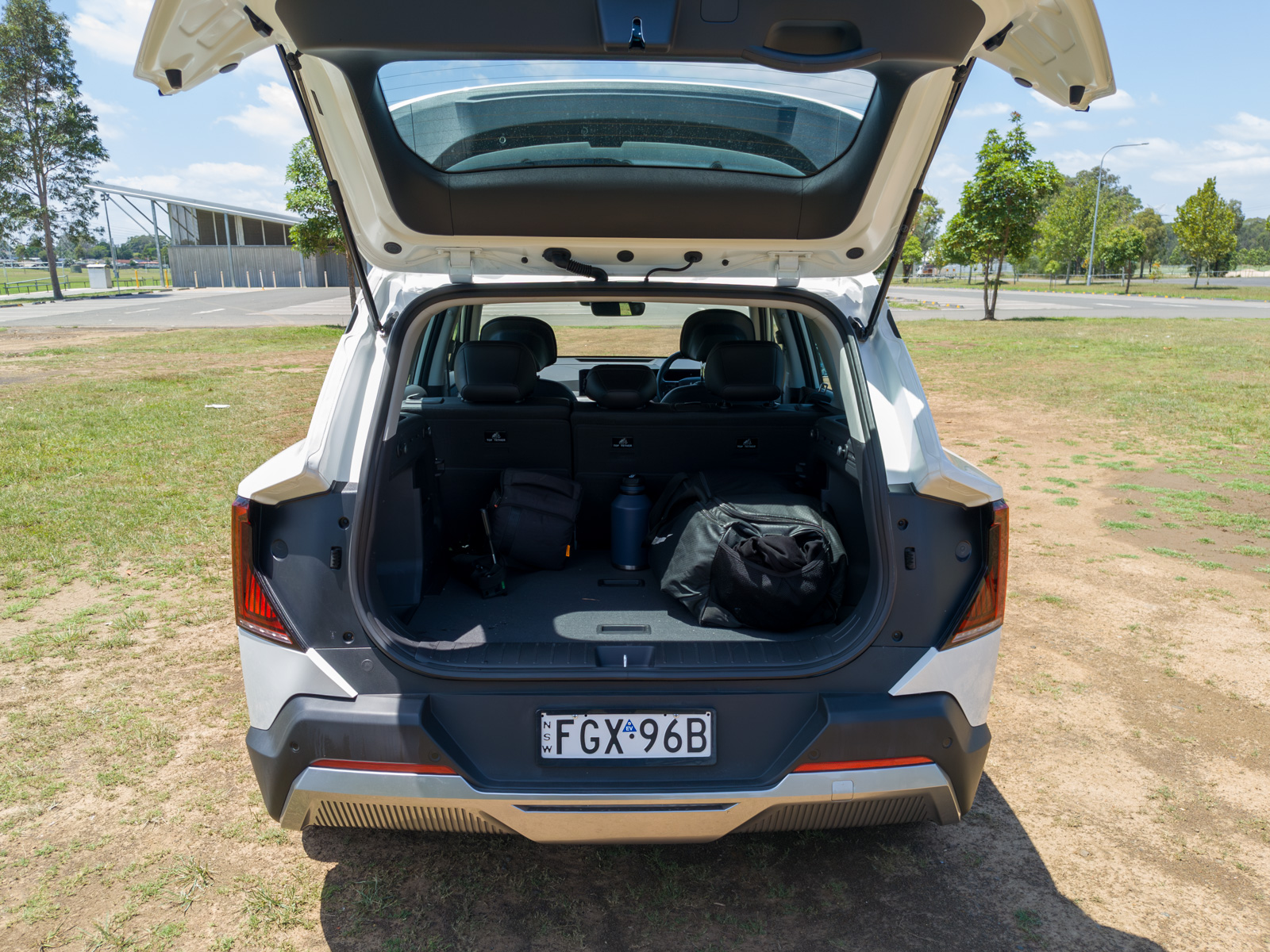 Open 513-litre boot of the Kia EV5 showing a flat loading floor and side storage.