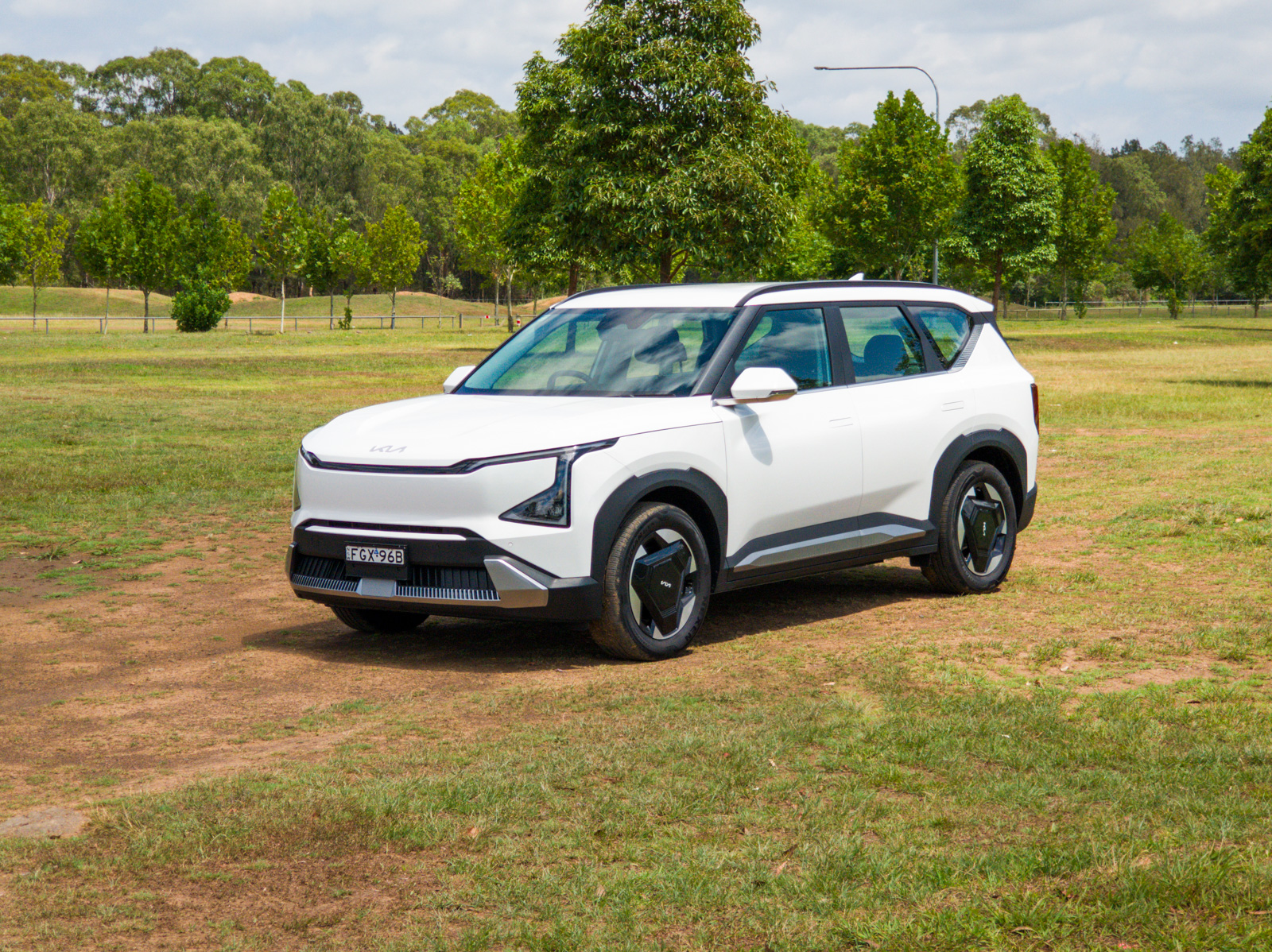 Hero shot of the 2025 Kia EV5 Standard Range electric SUV in a lifestyle setting.