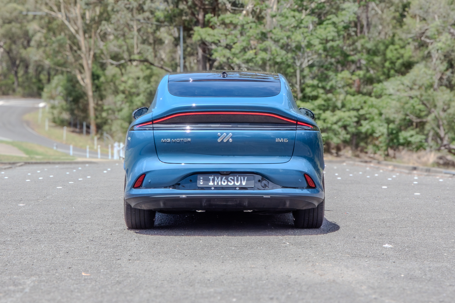 Rear view of the 2025 MG IM6 Performance highlighting the full-width LED light bar and sporty diffuser.