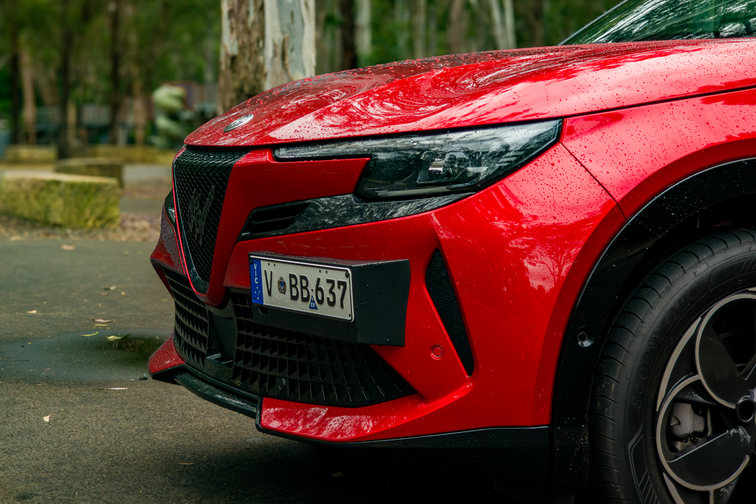 Front bumper aerodynamic splitter and red lower trim accent