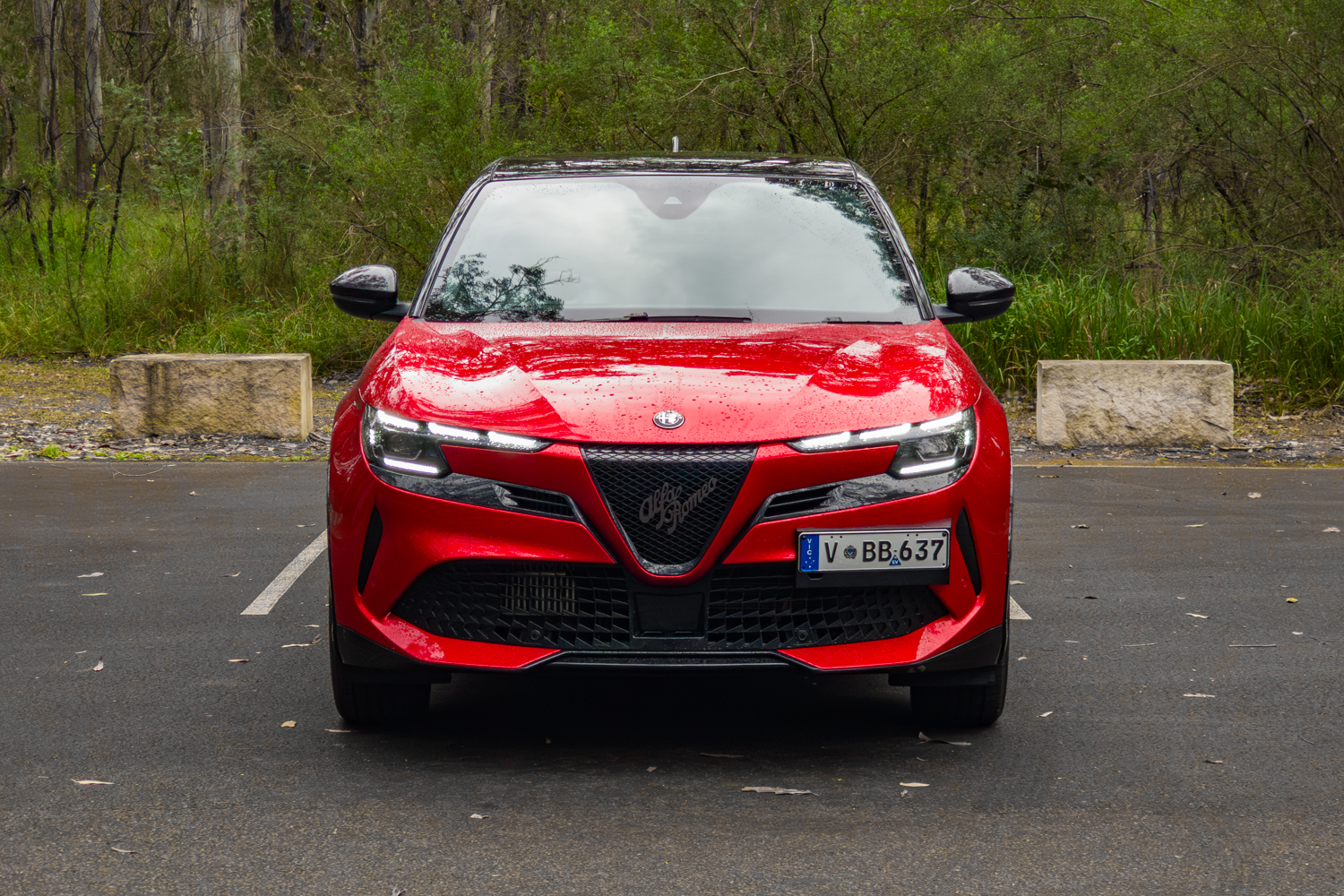 2026 Alfa Romeo Junior Ibrida straight-on front view with DRLs lit