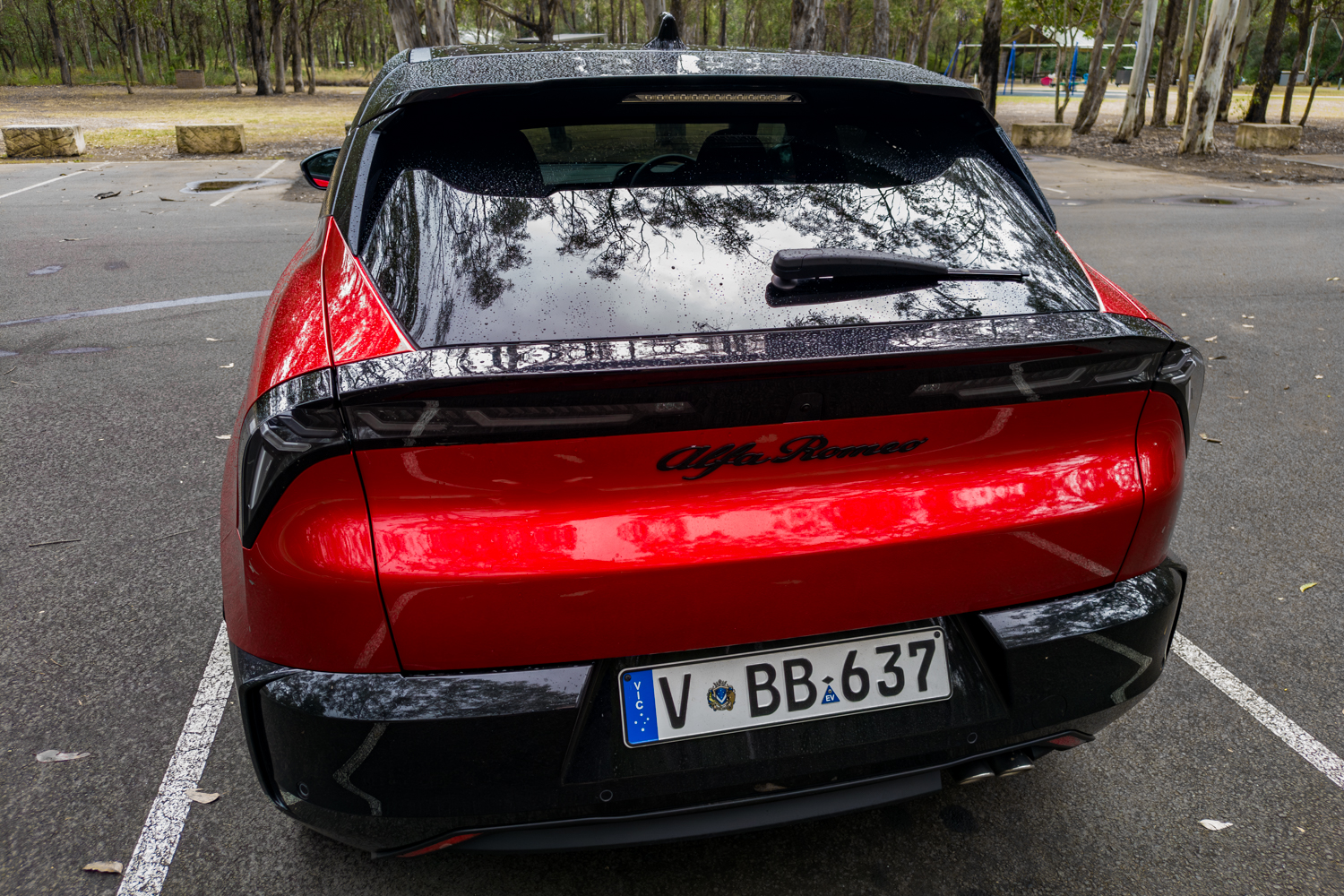 Overhead rear view showing the contrast black roof and full-width LED taillight bar