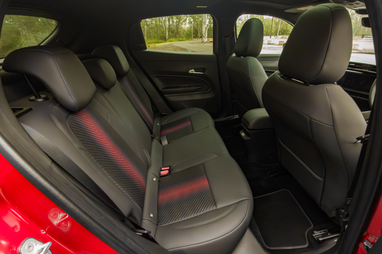 2026 Alfa Romeo Junior Ibrida rear passenger seats with red accent stitching