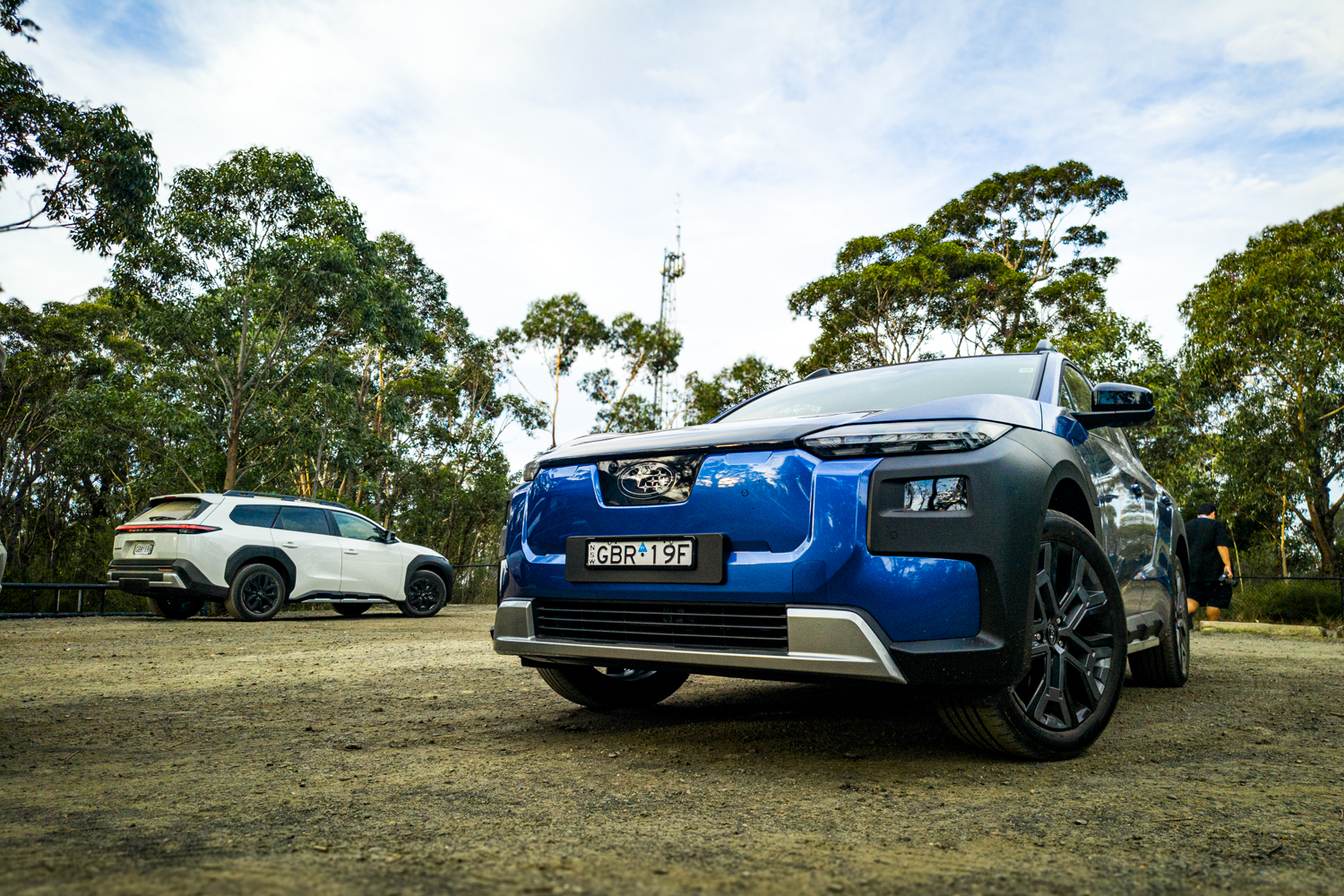 Blue 2026 Subaru Trailseeker AWD Touring electric SUV on a rocky outcrop, front three-quarter