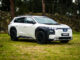 White 2026 Subaru Trailseeker electric SUV, front three-quarter from the driver side, parked on grass