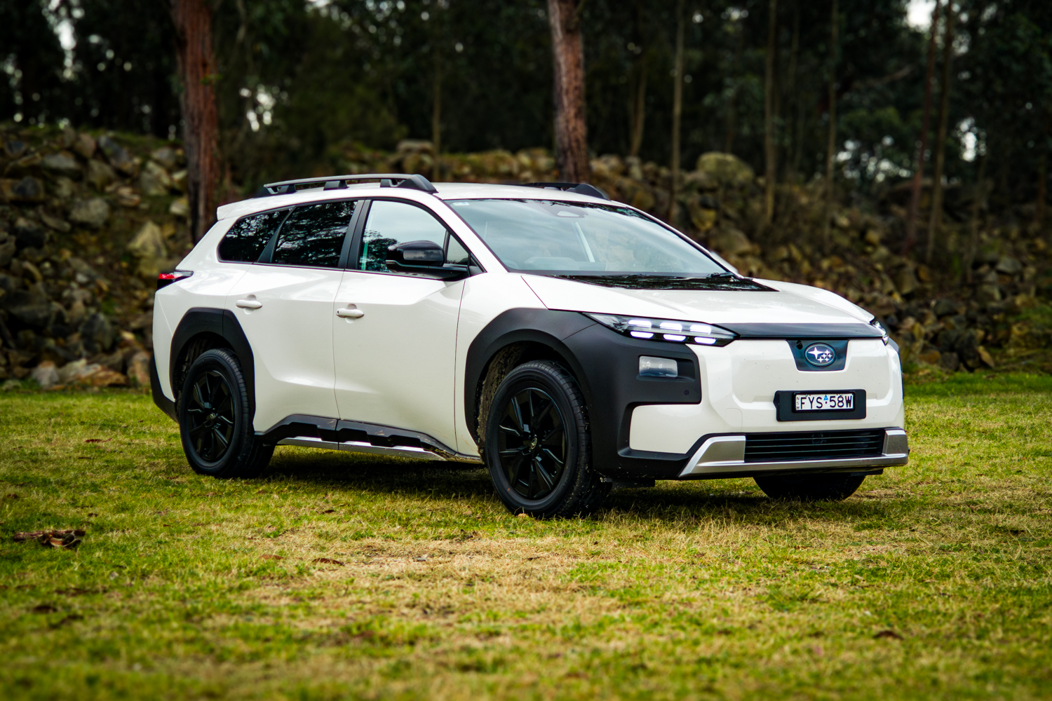 White 2026 Subaru Trailseeker electric SUV, front three-quarter from the driver side, parked on grass
