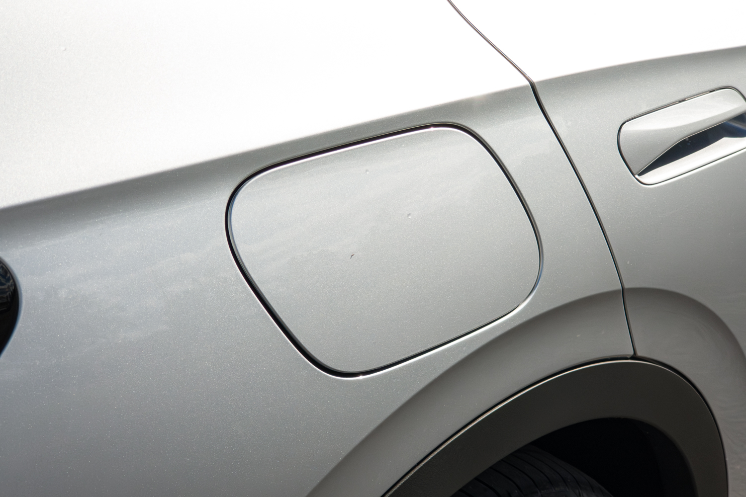 Closed charging flap on the right rear quarter of the silver 2026 Volkswagen ID.4 GTX