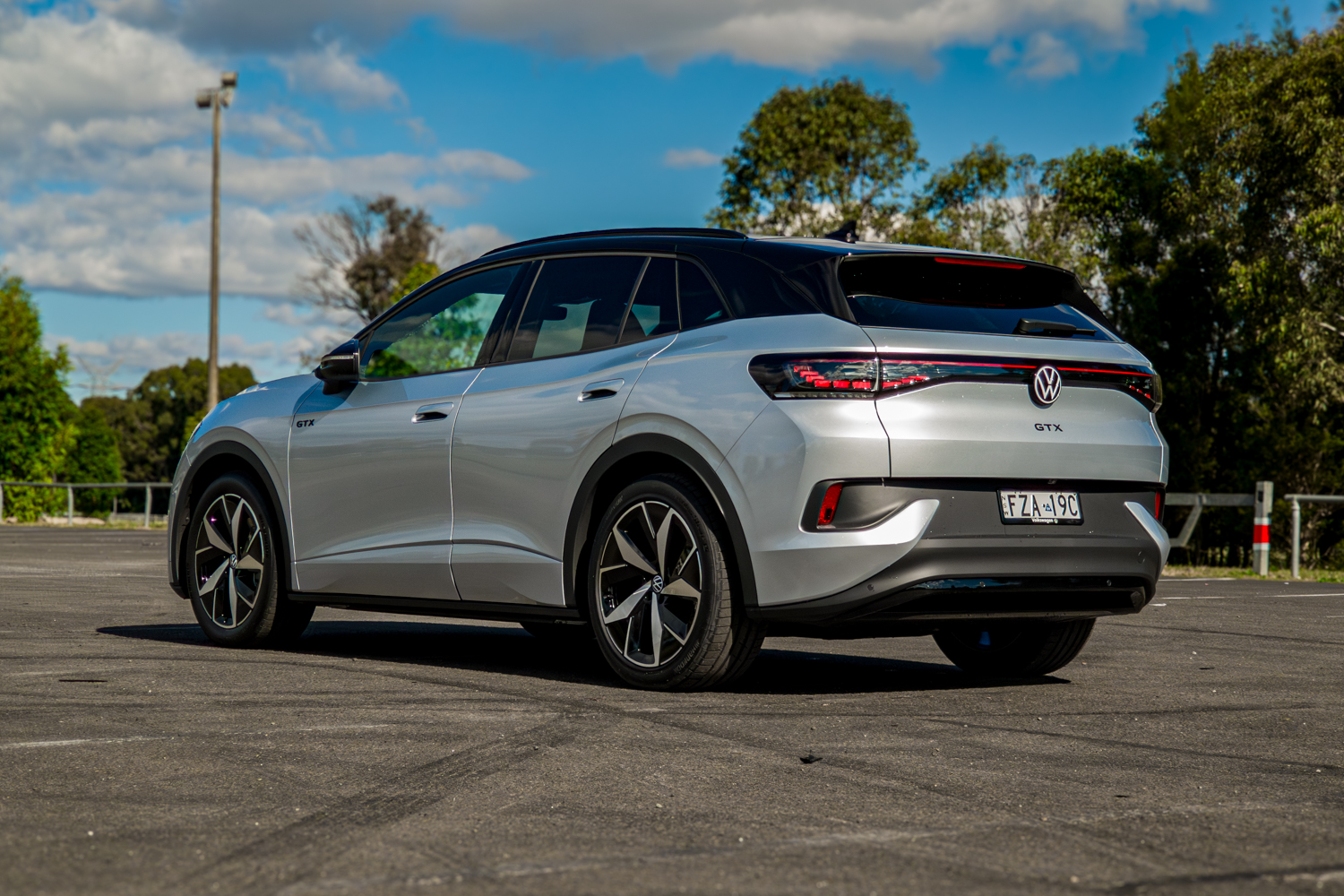 Rear passenger-side three-quarter of the silver 2026 Volkswagen ID.4 GTX