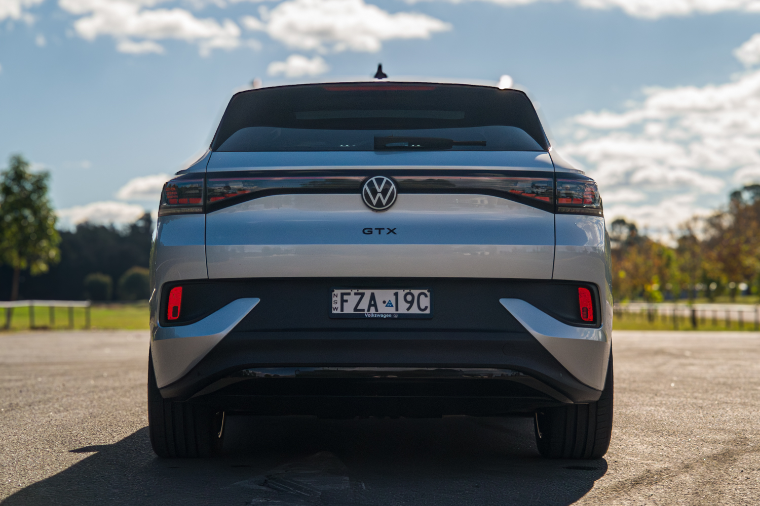 Rear view of the silver 2026 Volkswagen ID.4 GTX showing the full-width light bar and GTX badge