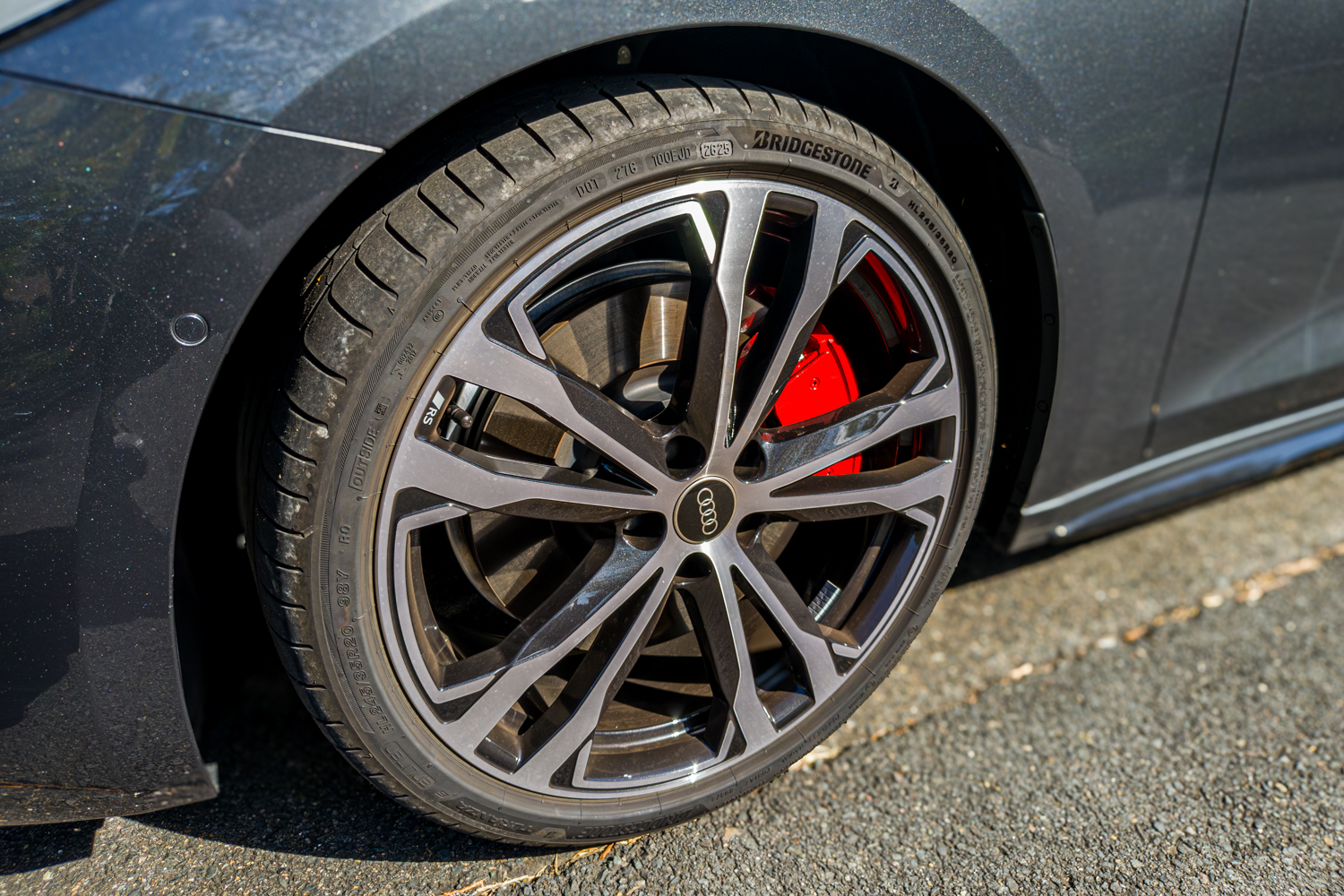 Close-up of the 2026 Audi A5 Sedan e-hybrid quattro alloy wheel with red brake caliper