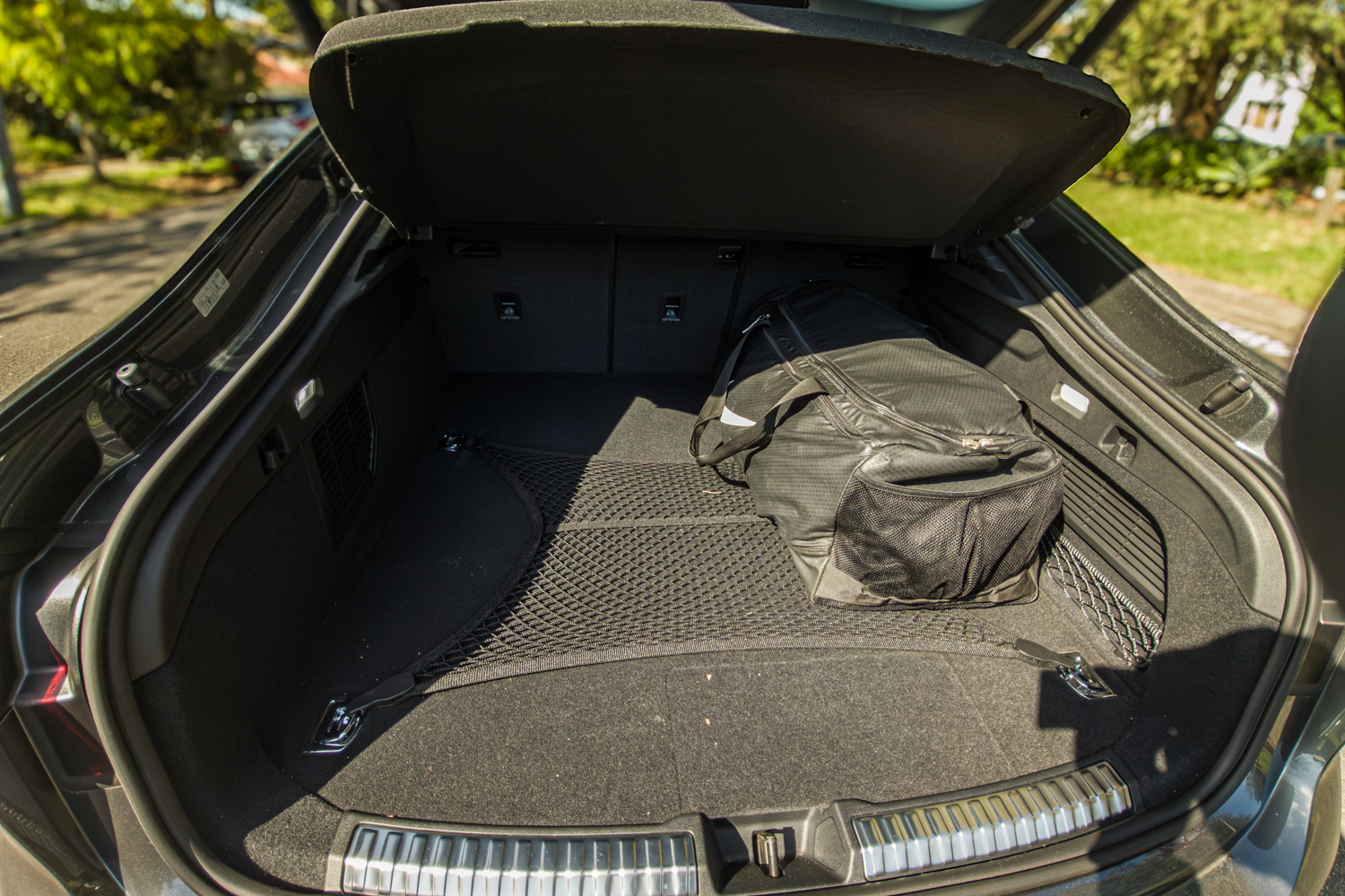 Open boot of the 2026 Audi A5 Sedan e-hybrid quattro showing cargo area and net