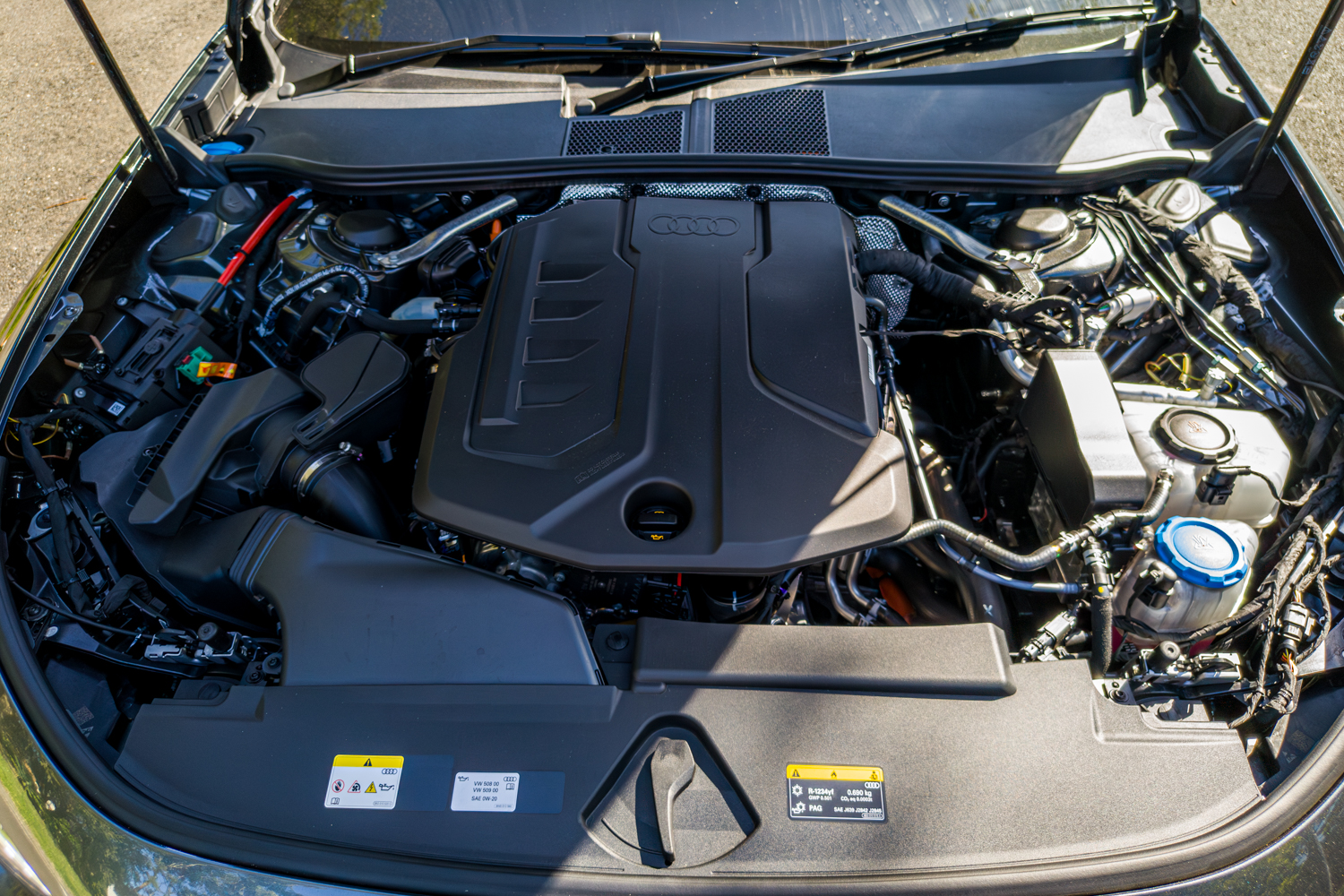Engine bay of the 2026 Audi A5 Sedan e-hybrid quattro showing e-hybrid powertrain