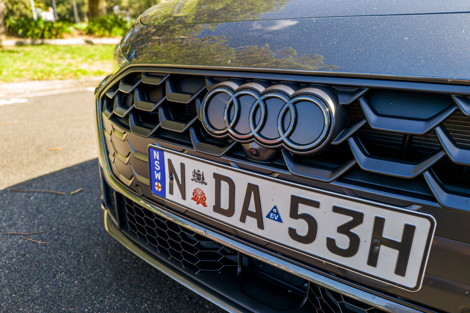 Close-up of 2026 Audi A5 Sedan e-hybrid quattro front grille and Audi four-ring badge