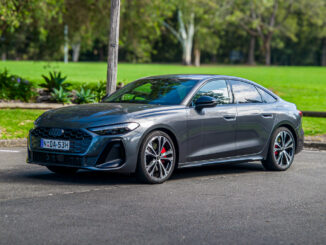 2026 Audi A5 Sedan e-hybrid quattro front three-quarter view in grey at a park