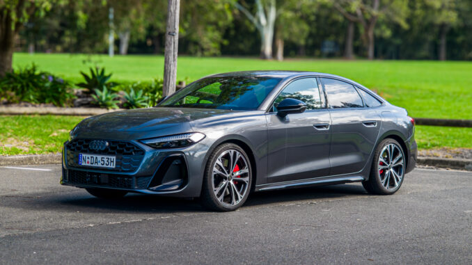 2026 Audi A5 Sedan e-hybrid quattro front three-quarter view in grey at a park