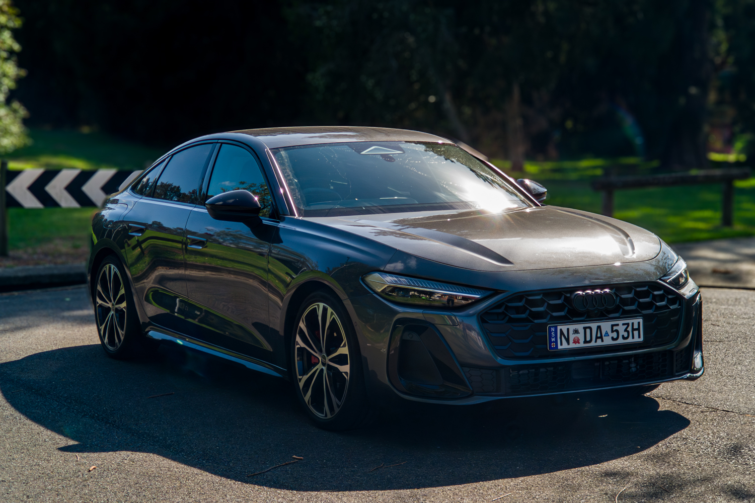 2026 Audi A5 Sedan e-hybrid quattro front three-quarter with dramatic sun backlighting