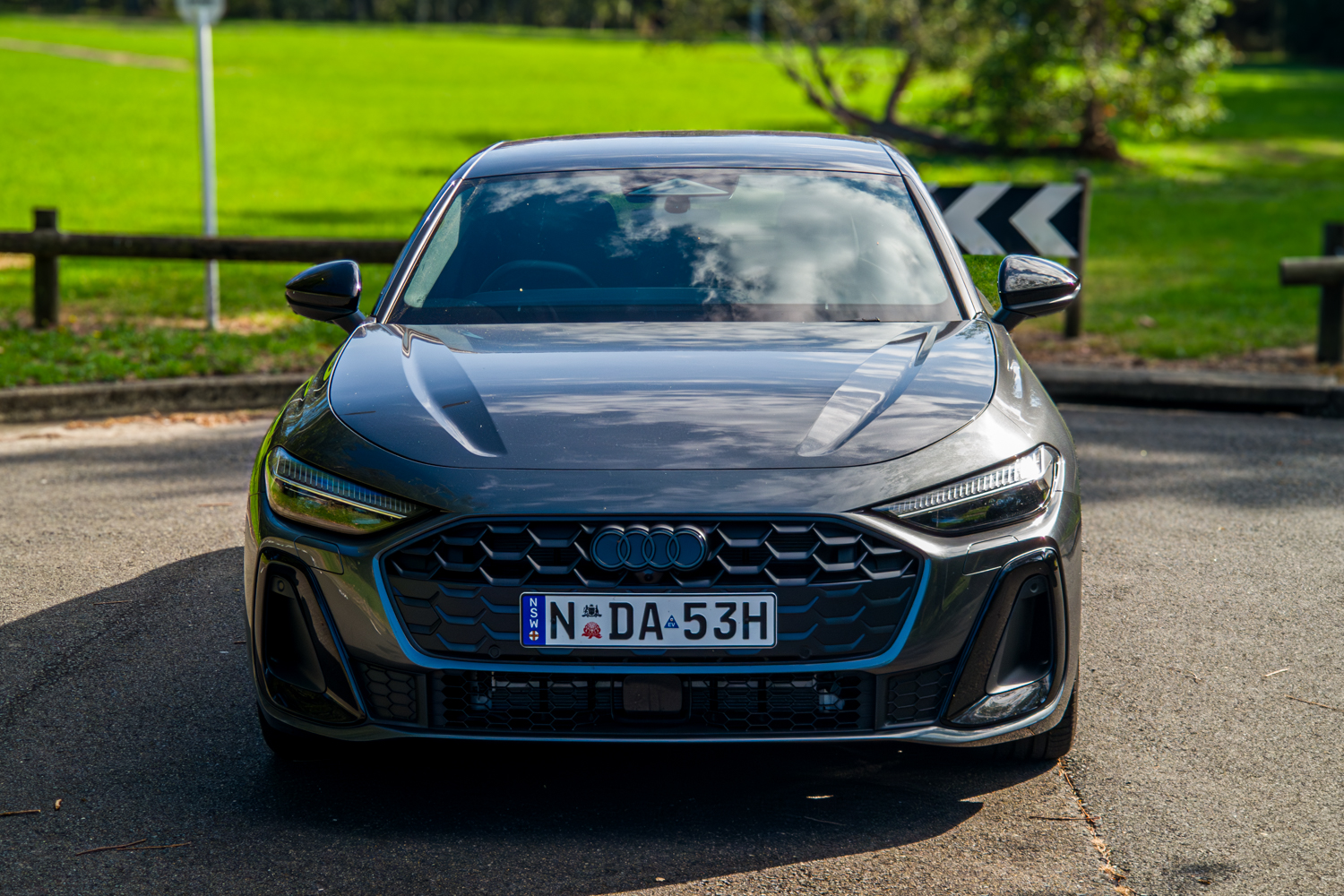 Close front view of the 2026 Audi A5 Sedan e-hybrid quattro showing blue e-hybrid grille accent