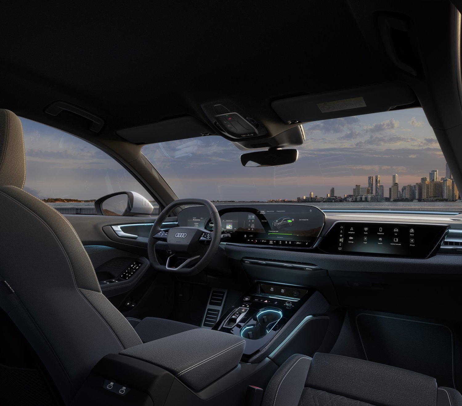 2026 Audi A5 e-hybrid quattro interior, front cabin from the passenger side with a city skyline through the windscreen