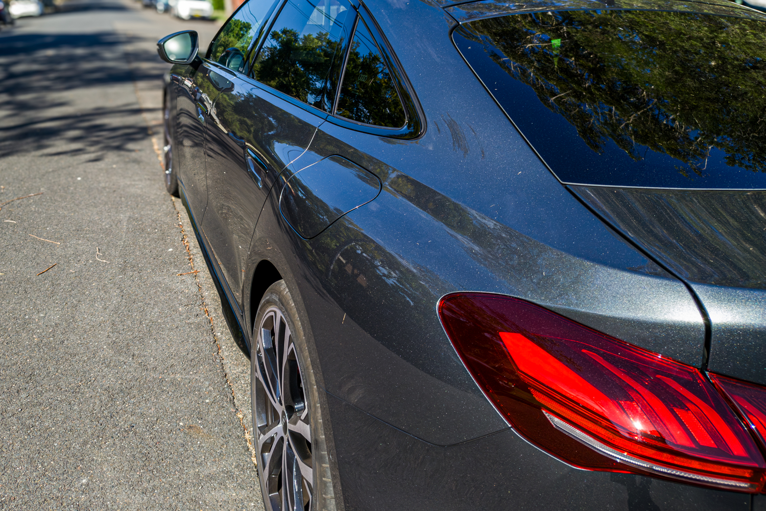 Rear quarter of the 2026 Audi A5 Sedan e-hybrid quattro showing coupe roofline and tail light
