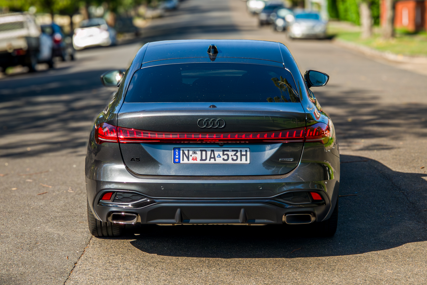 Straight-on rear view of the 2026 Audi A5 Sedan e-hybrid quattro showing full LED light bar