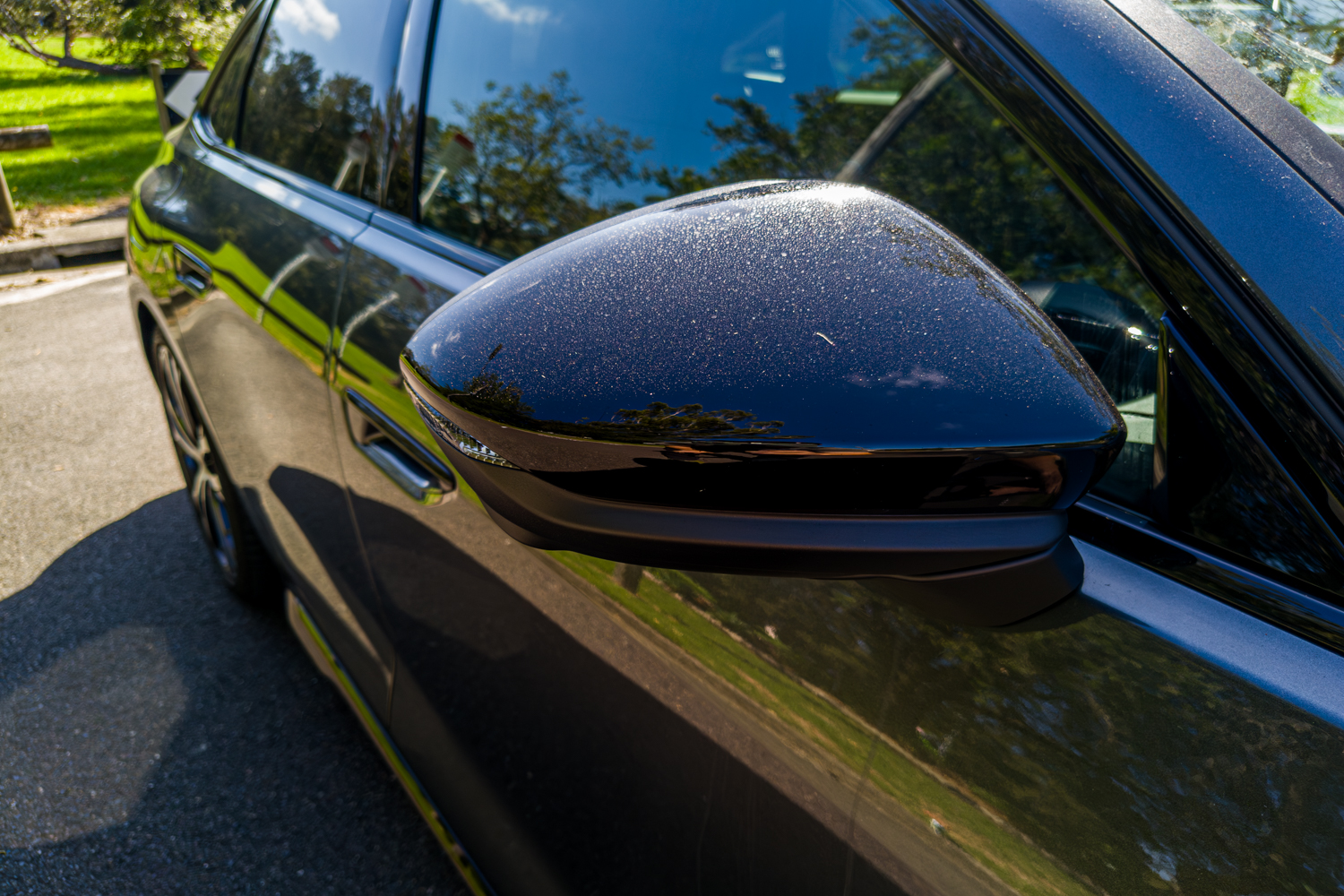 Close-up of the 2026 Audi A5 Sedan e-hybrid quattro gloss-black passenger's wing mirror