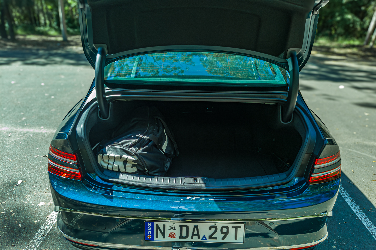 2026 Genesis G80 Electrified Matira Blue boot open showing cargo space from rear