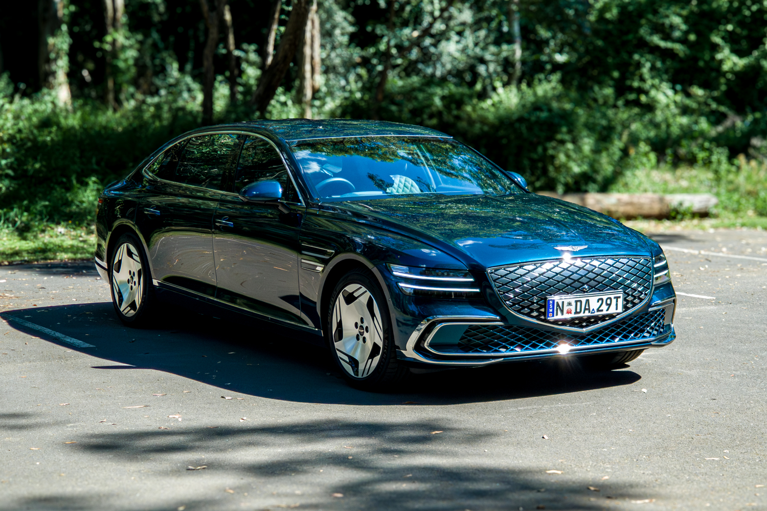 2026 Genesis G80 Electrified Matira Blue front three quarter driver side on open road surface