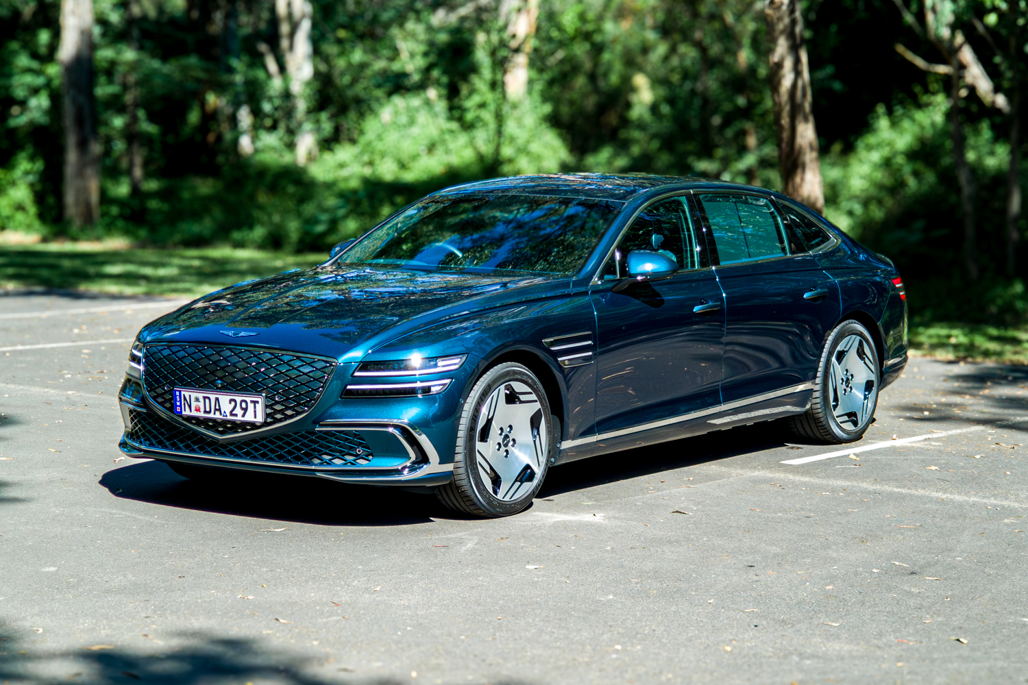 2026 Genesis G80 Electrified Matira Blue front three quarter driver side in sunlight vibrant colour