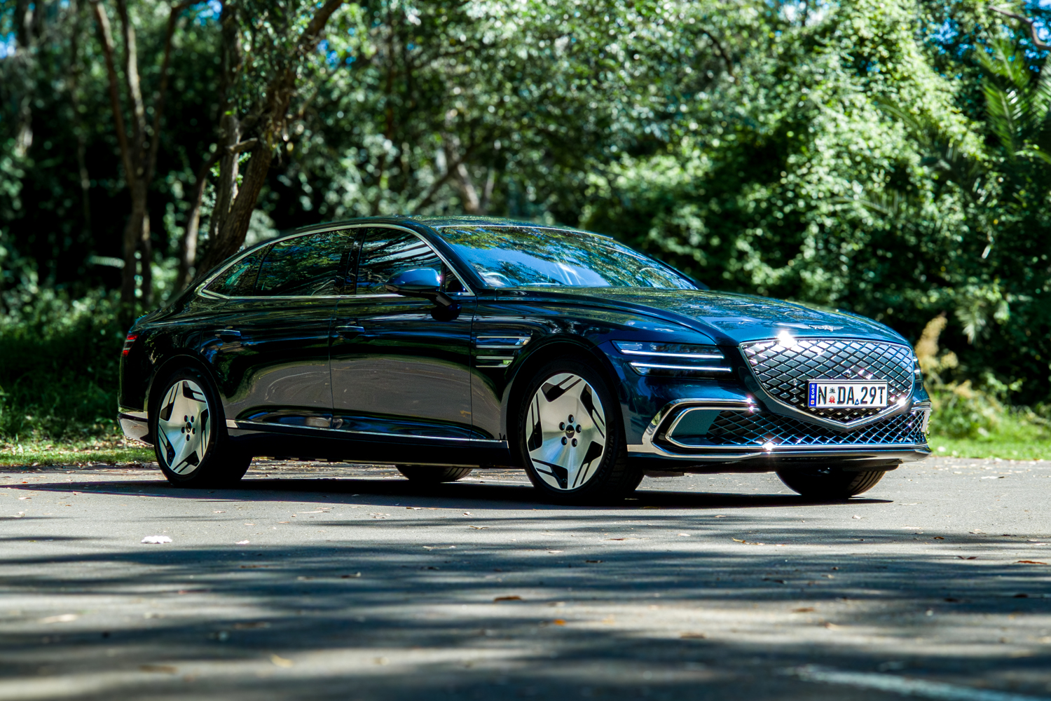 2026 Genesis G80 Electrified Matira Blue front three quarter view from driver side right