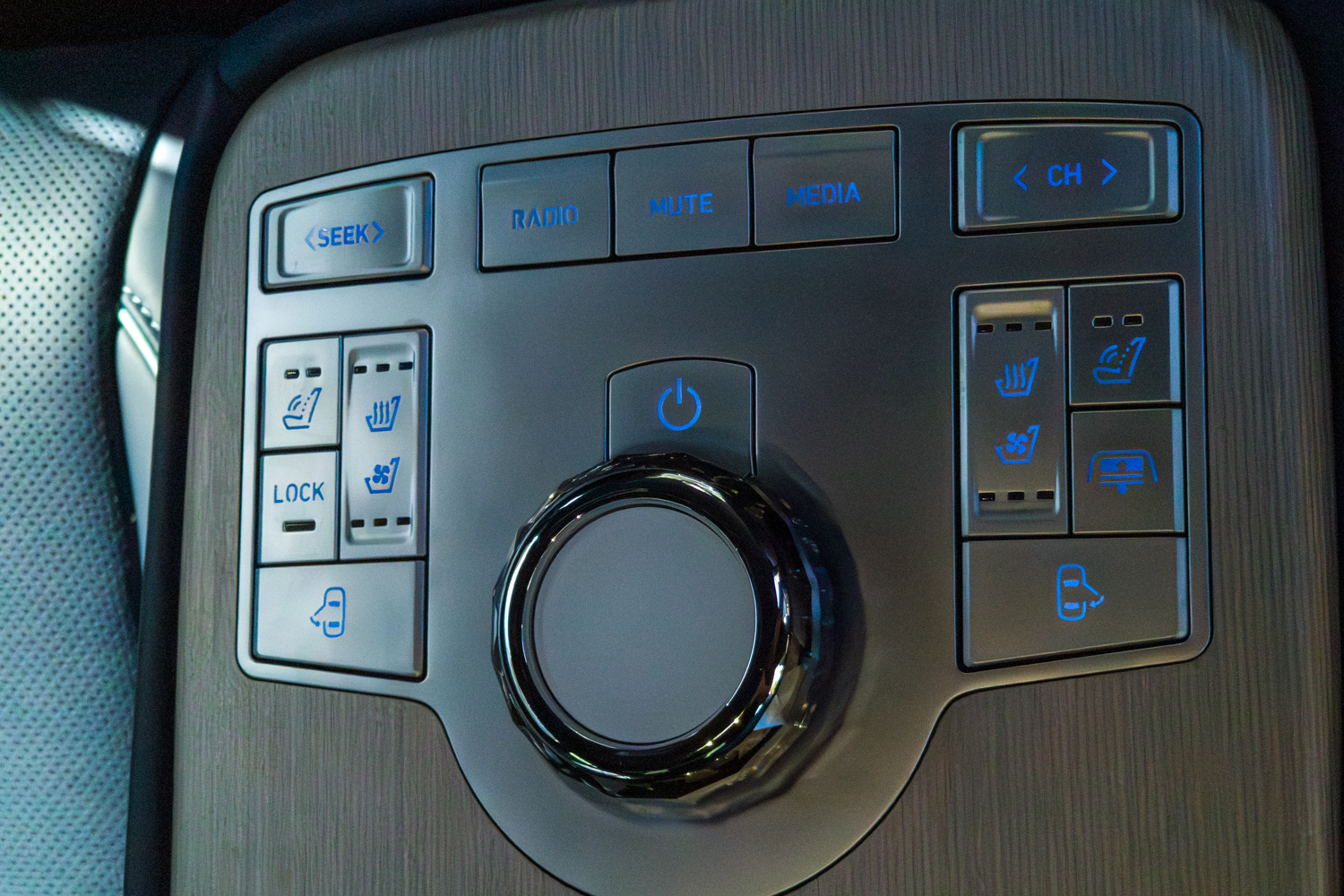 2026 Genesis G80 Electrified rear console control panel showing illuminated audio seat and climate controls