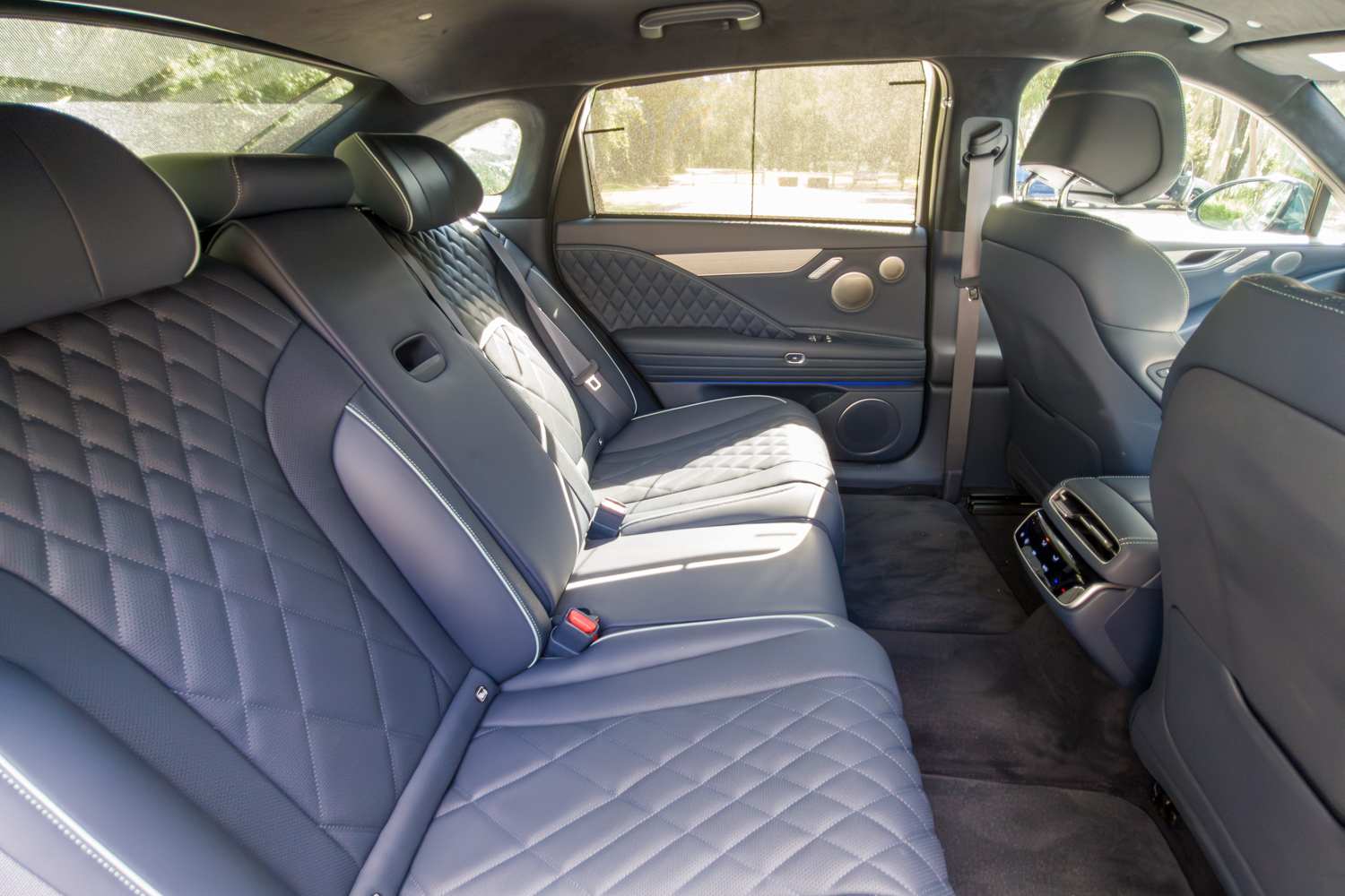 2026 Genesis G80 Electrified rear bench seats from passenger side showing quilted leather and rear climate vents