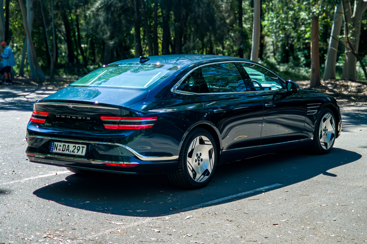 2026 Genesis G80 Electrified Matira Blue rear three quarter full view from driver side right