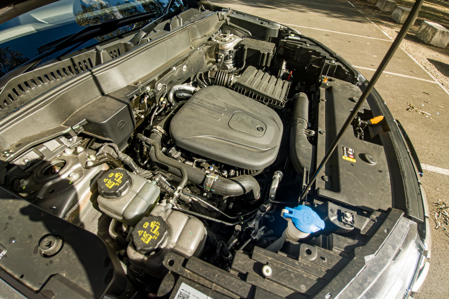 Engine bay of the 2026 GWM Haval H6 PHEV showing the petrol engine of the hybrid system