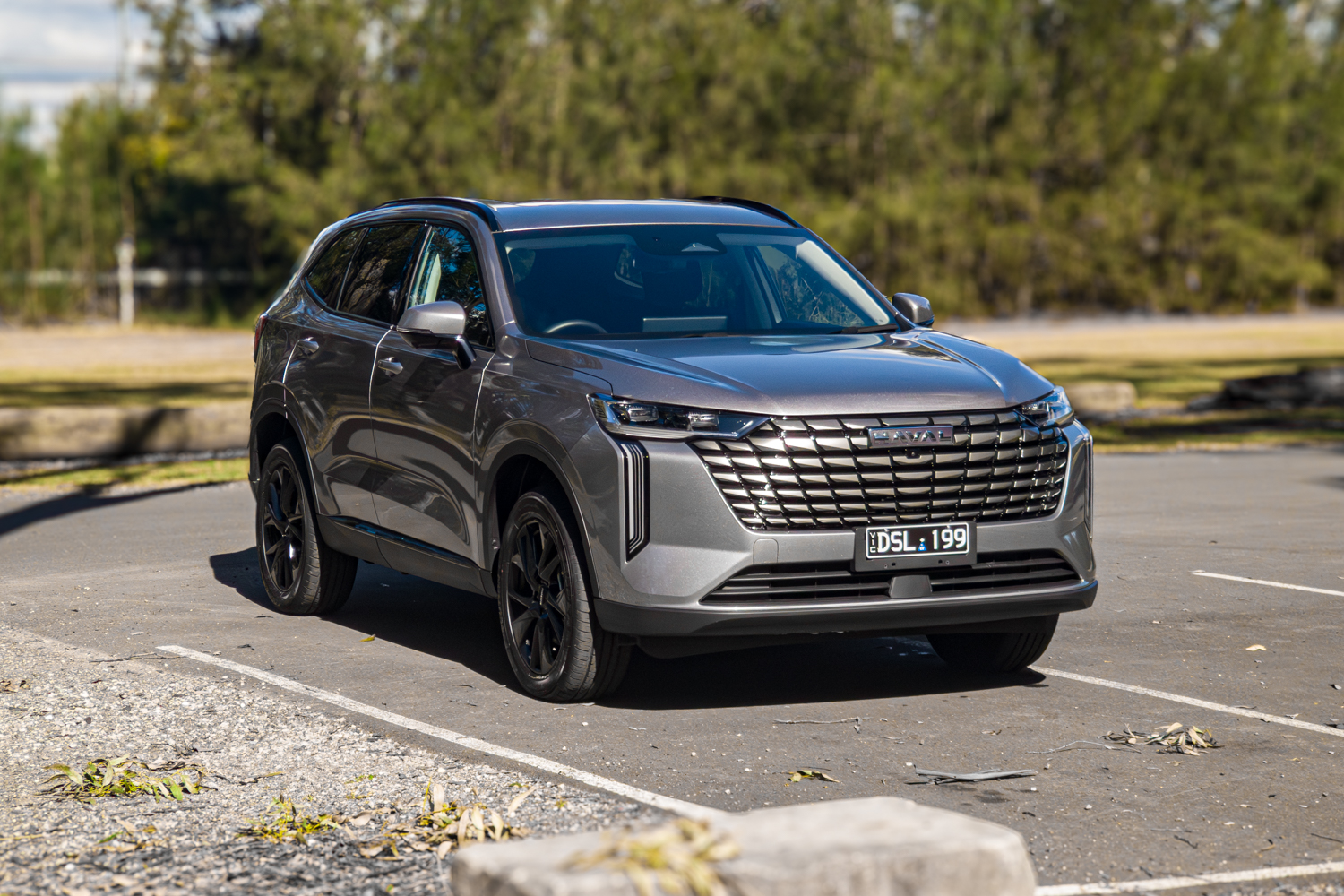 Low front angle of the grey 2026 GWM Haval H6 PHEV with black alloy wheels