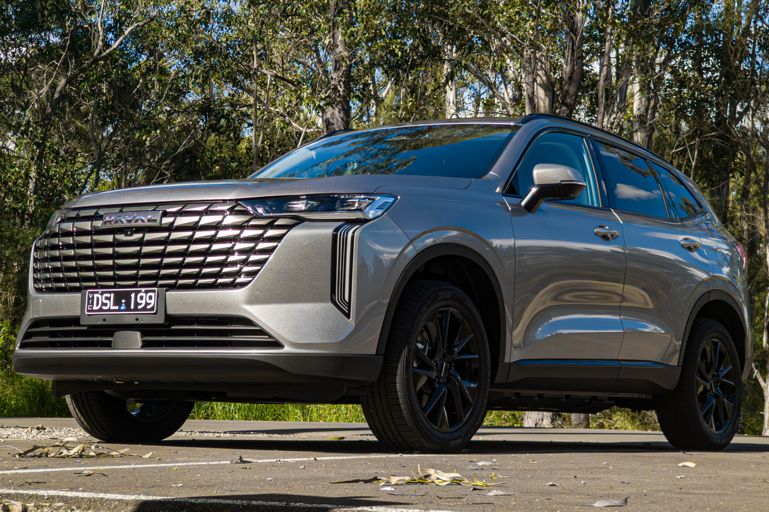 Front three quarter view of the grey 2026 GWM Haval H6 PHEV from the passenger side