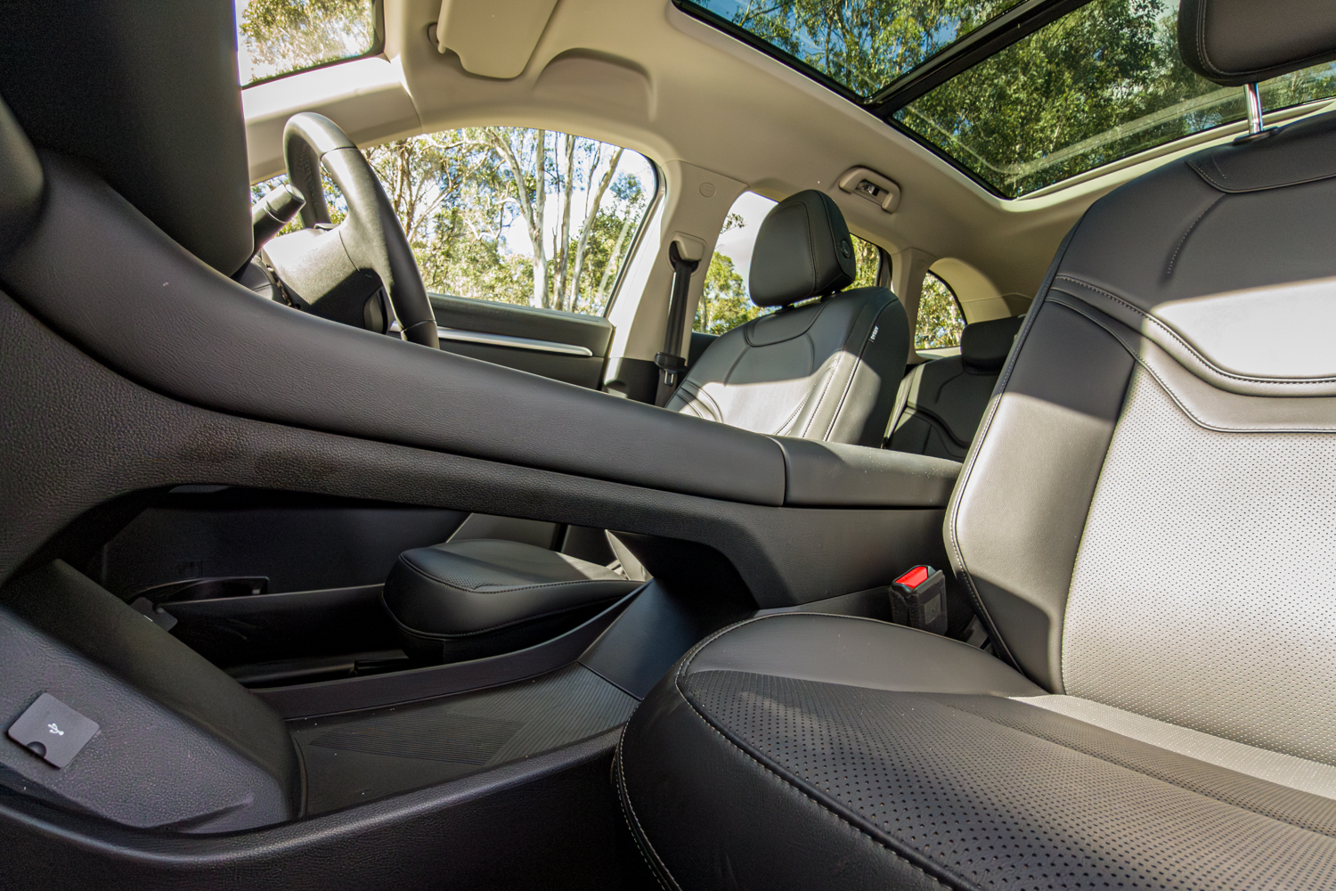 Two tone front seats of the 2026 GWM Haval H6 PHEV under the panoramic sunroof