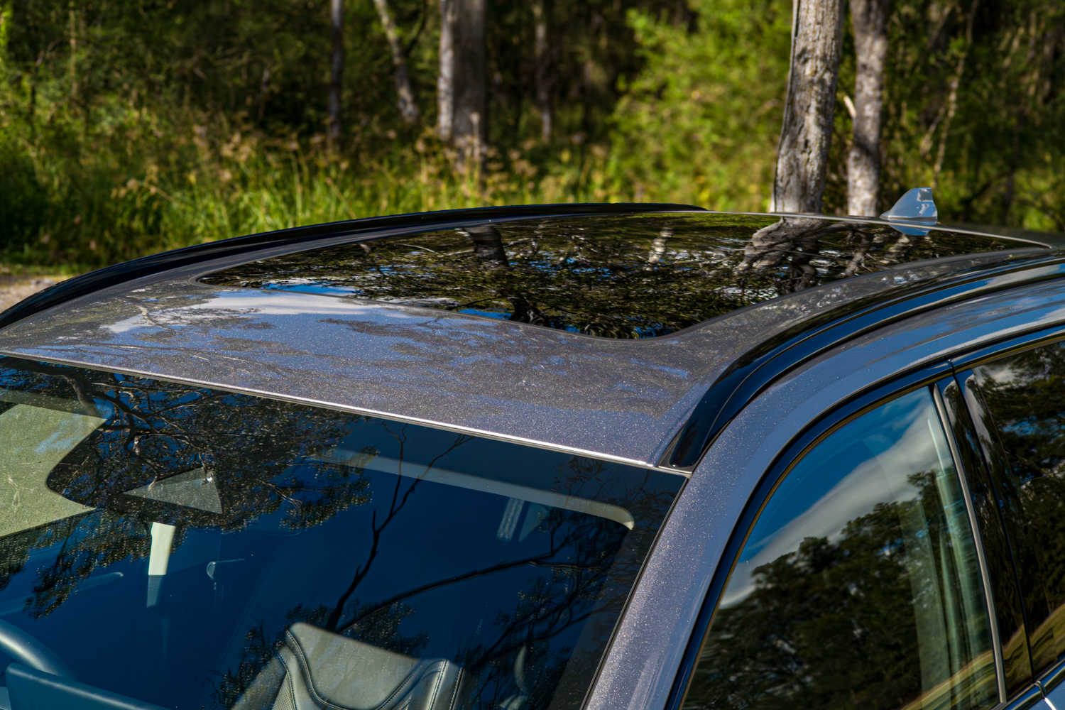 Roof of the 2026 GWM Haval H6 PHEV showing the panoramic sunroof glass and roof rails