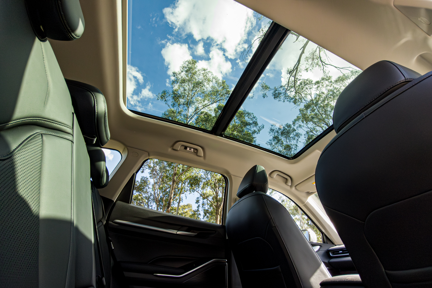 View up through the 2026 GWM Haval H6 PHEV panoramic sunroof from the back seat