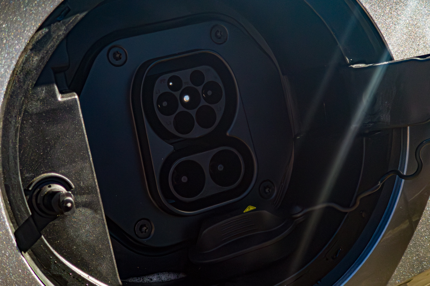 Close up of the 2026 GWM Haval H6 PHEV charging port with AC and DC connections