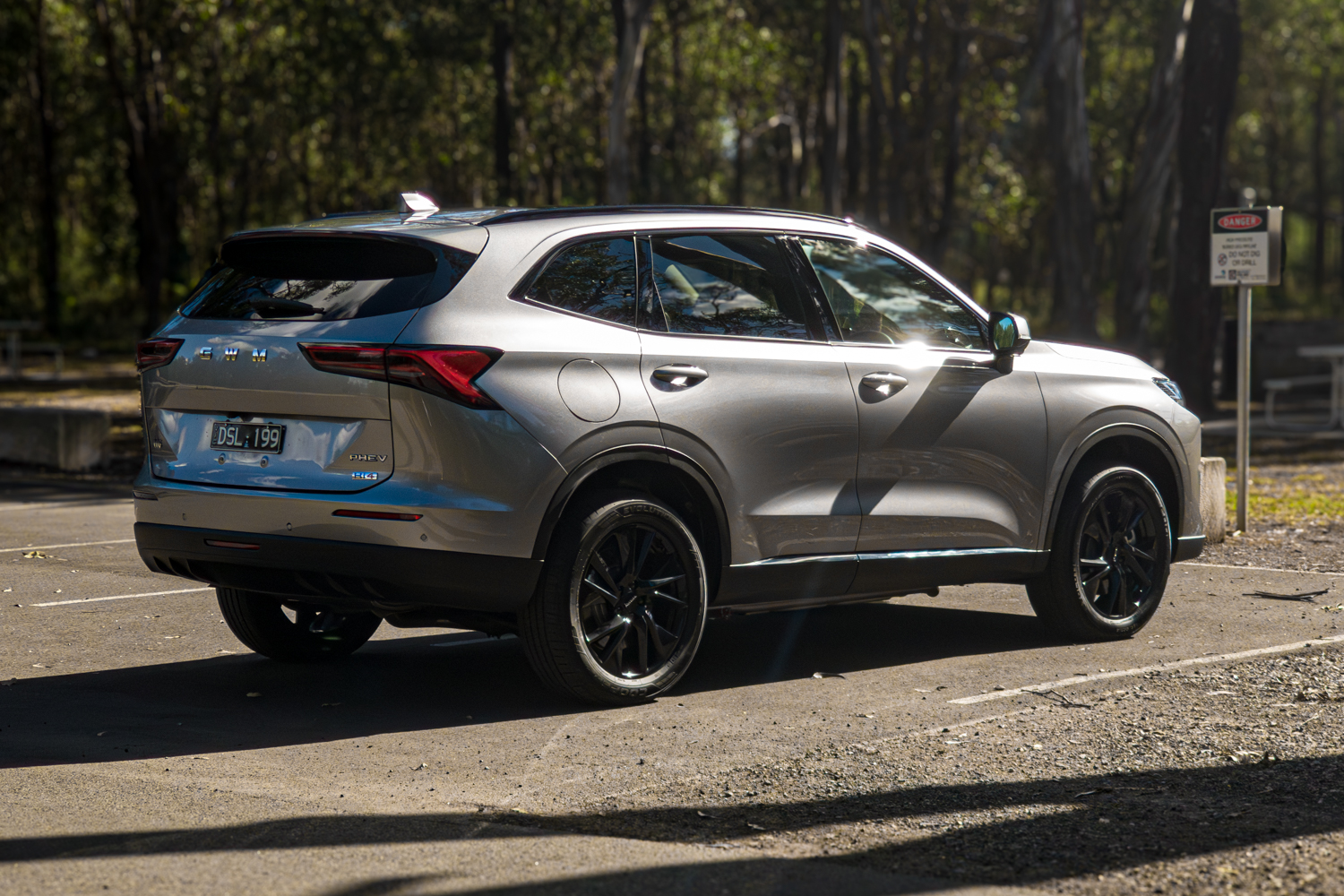 Rear three quarter view of the grey 2026 GWM Haval H6 PHEV from the driver side