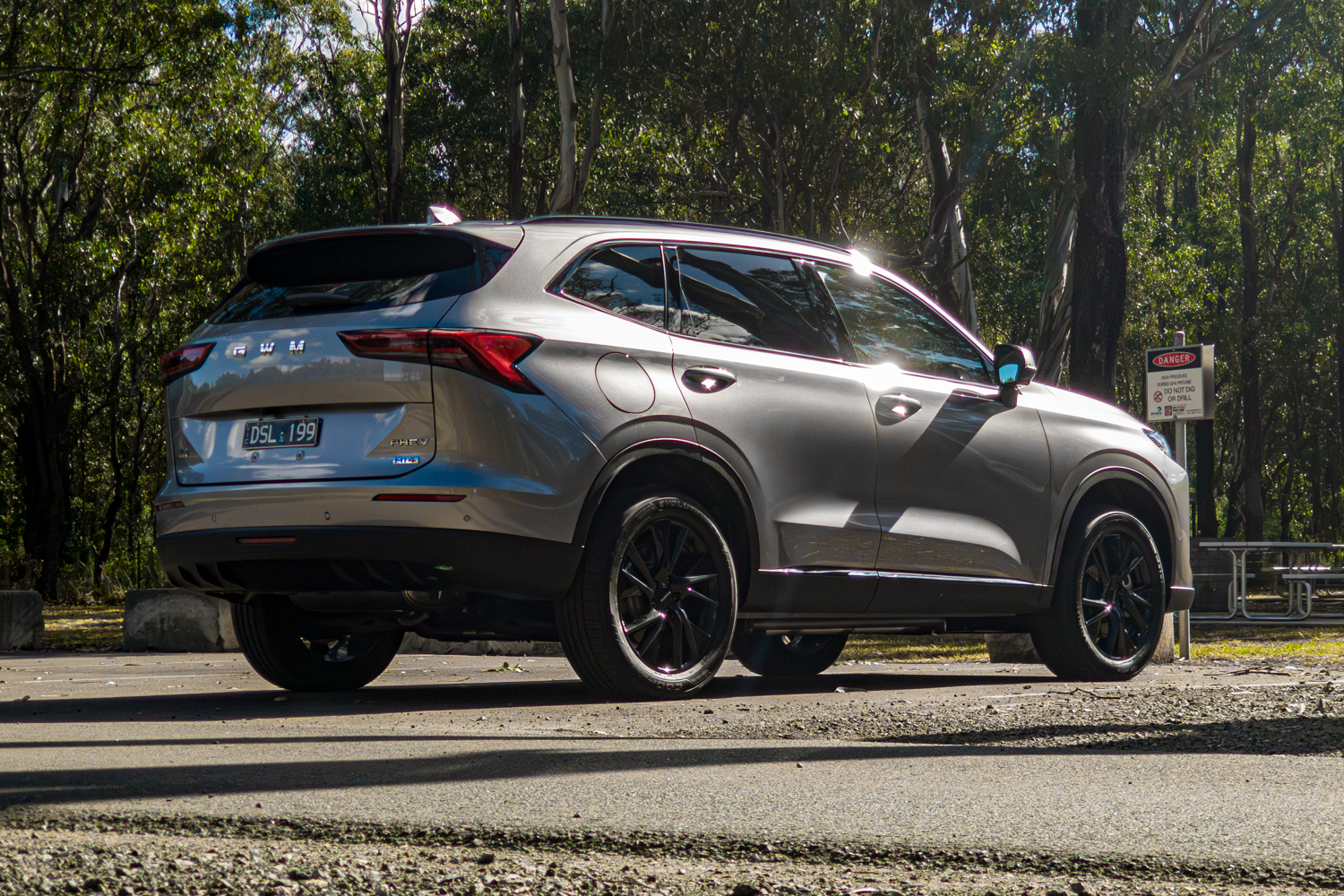 Low rear three quarter view of the grey 2026 GWM Haval H6 PHEV