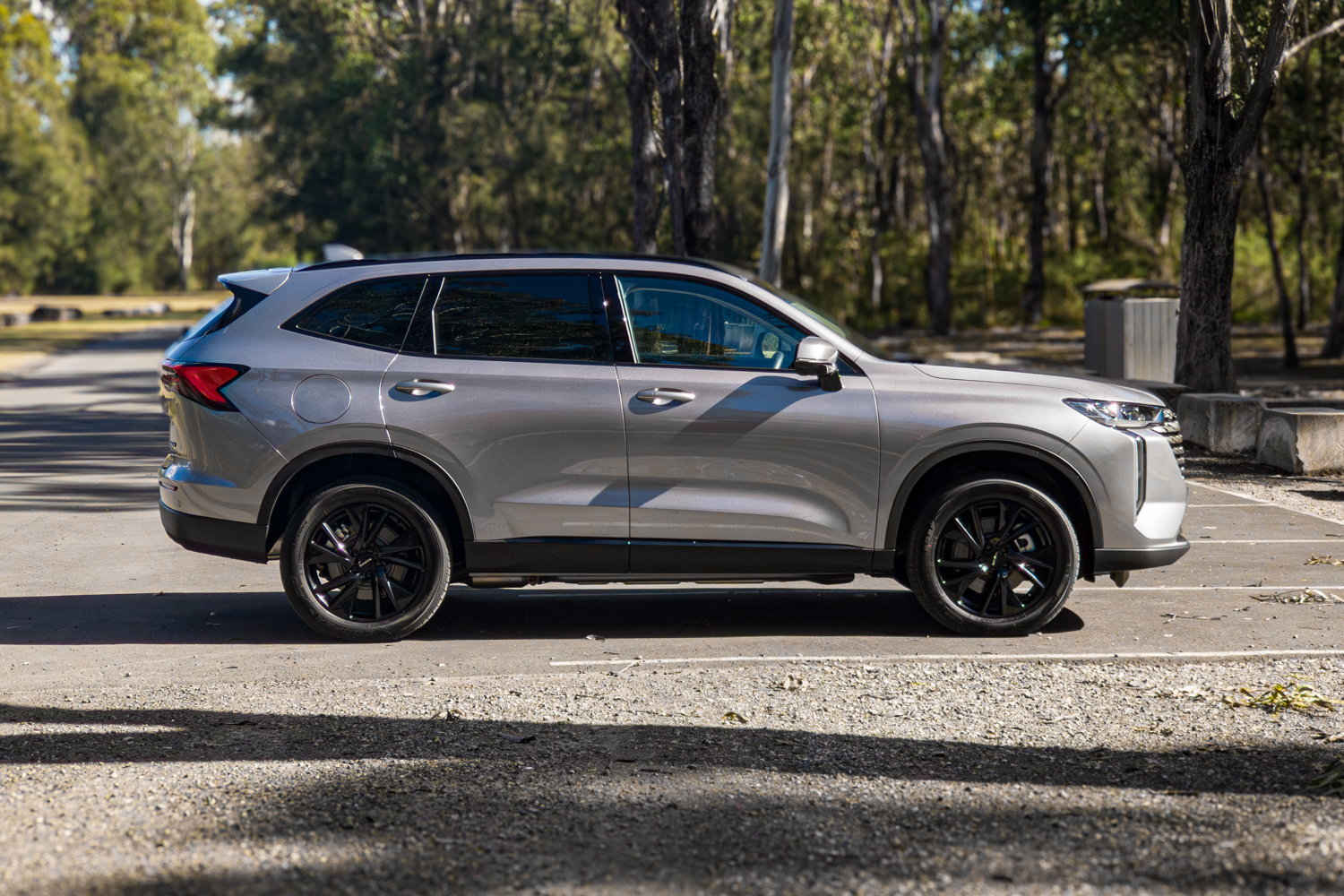 Driver side profile of the grey 2026 GWM Haval H6 PHEV with black alloy wheels