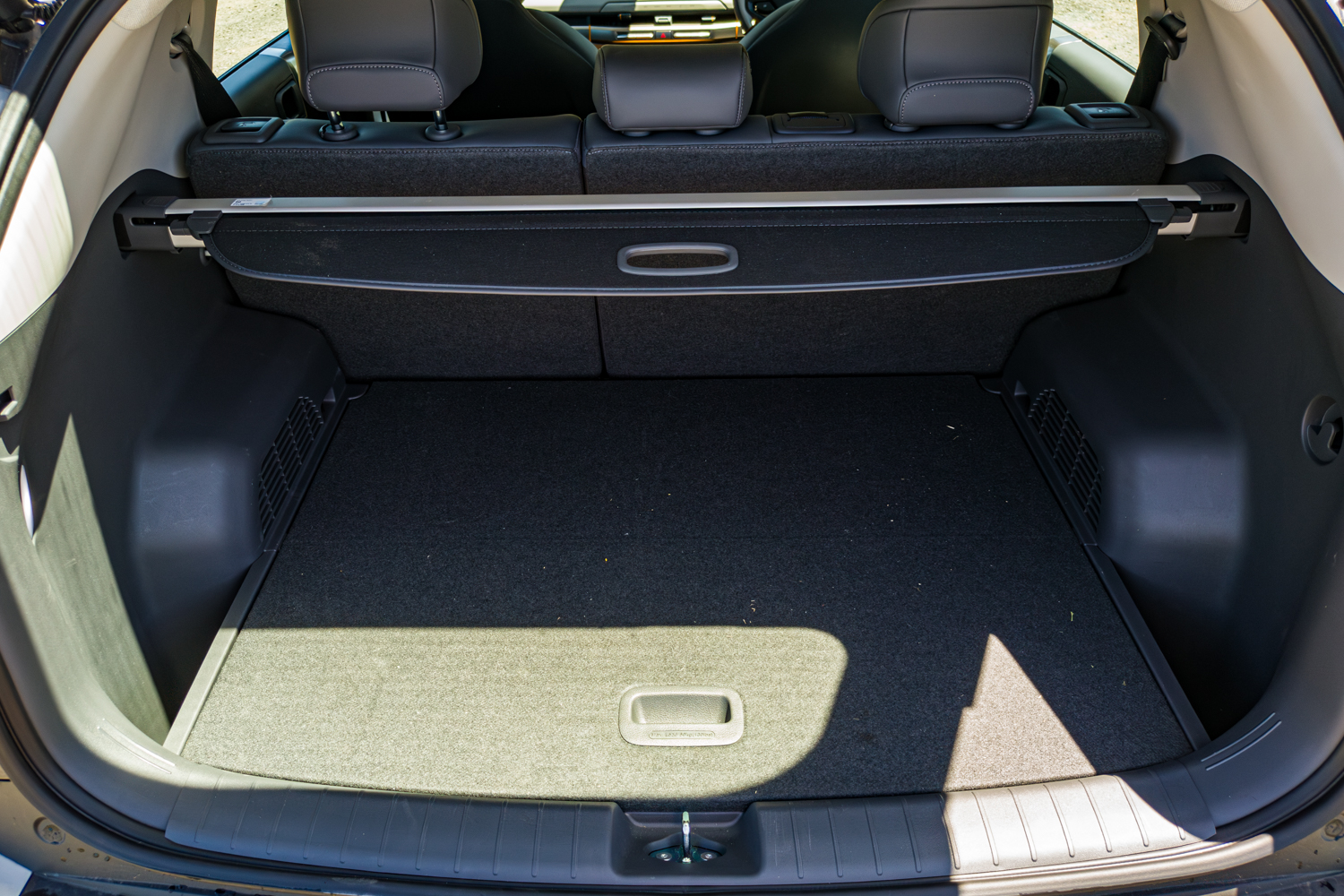 Empty boot of the 2026 Kia EV3 Earth Long Range with cargo cover and rear seats up