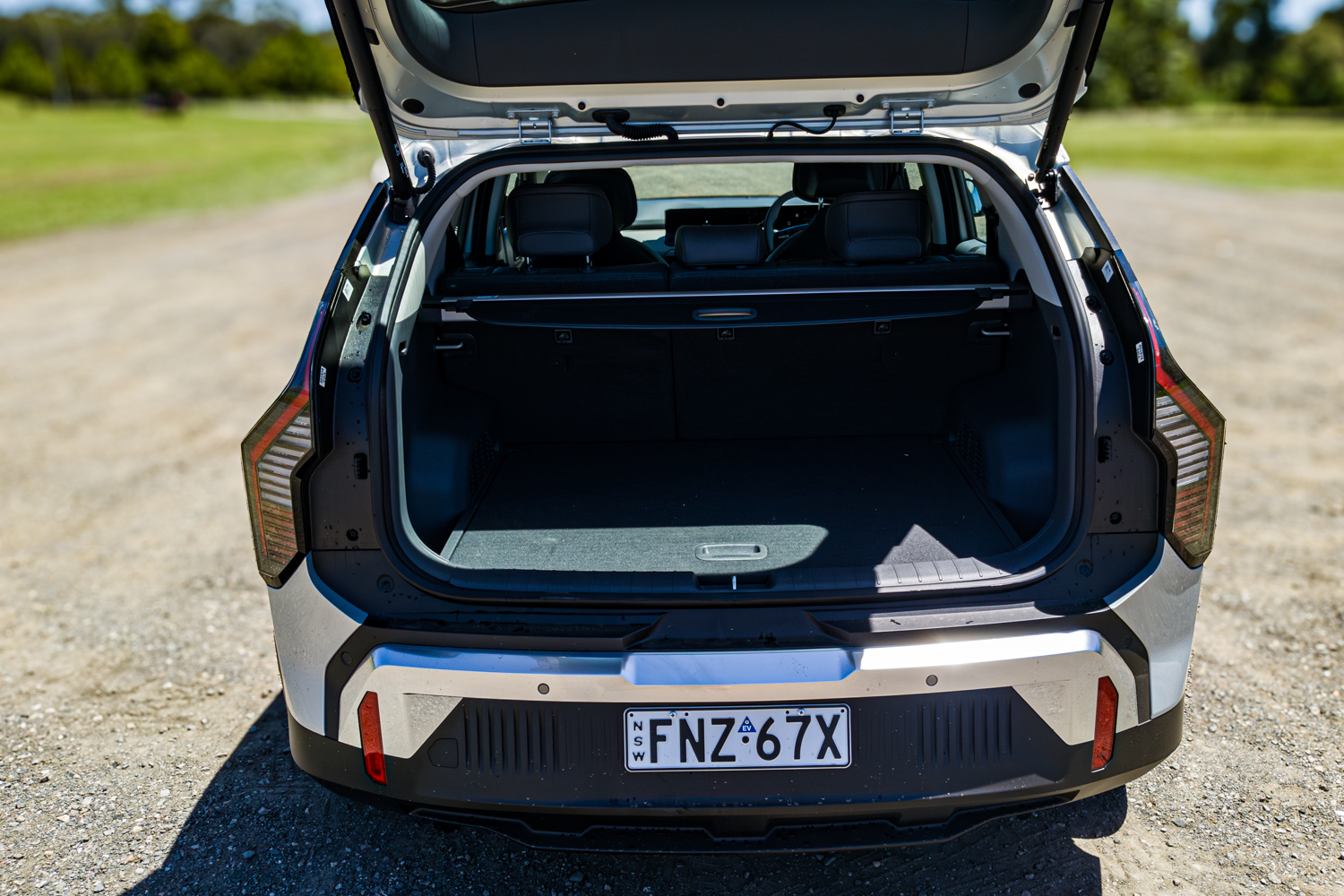 Rear view of the 2026 Kia EV3 Earth Long Range with the power tailgate open