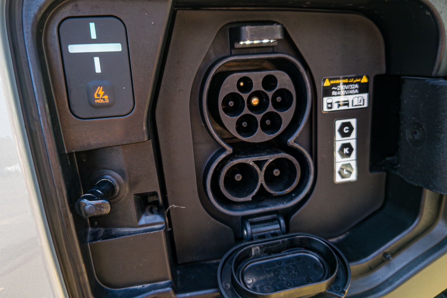 Close-up of the open CCS Type 2 charging port on the 2026 Kia EV3 Earth Long Range