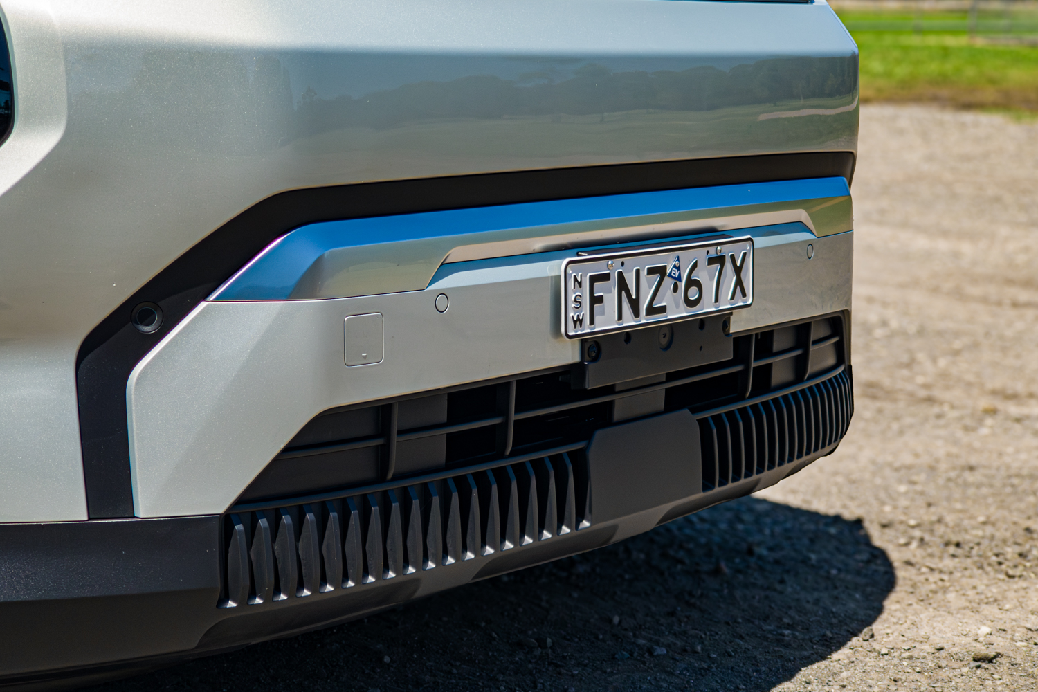 Close-up of the front bumper, lower intake and sensors on the 2026 Kia EV3 Earth Long Range with NSW plate