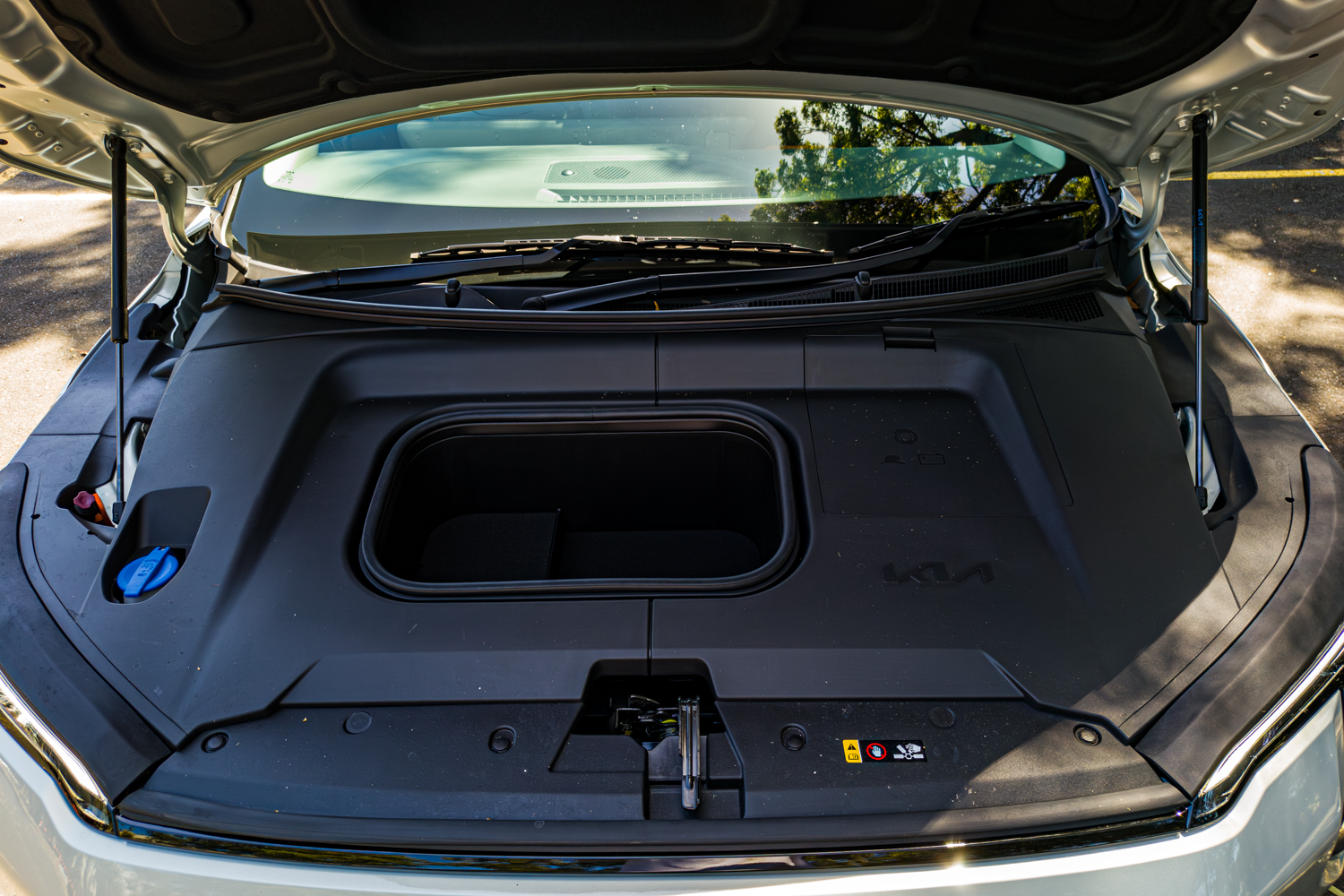 Open front boot or frunk of the 2026 Kia EV3 Earth Long Range showing storage under the bonnet
